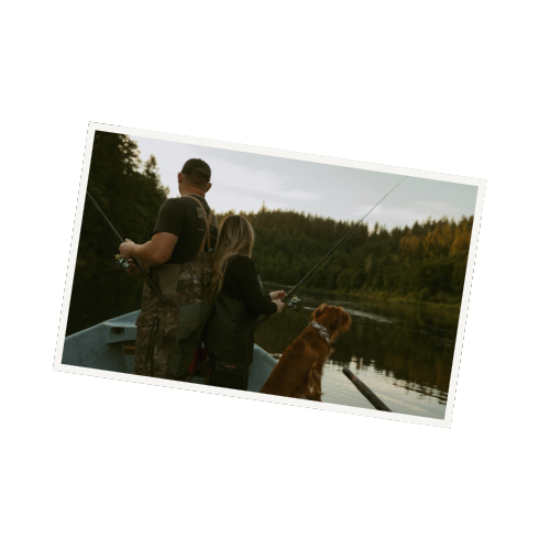 People enjoying a peaceful boat ride on a lake surrounded by forest.