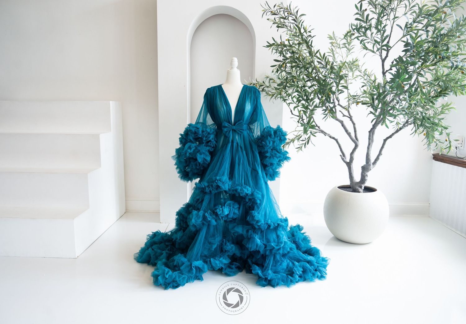 A vibrant teal tulle dress with ruffles is displayed in multiple angles against a white minimal backdrop.