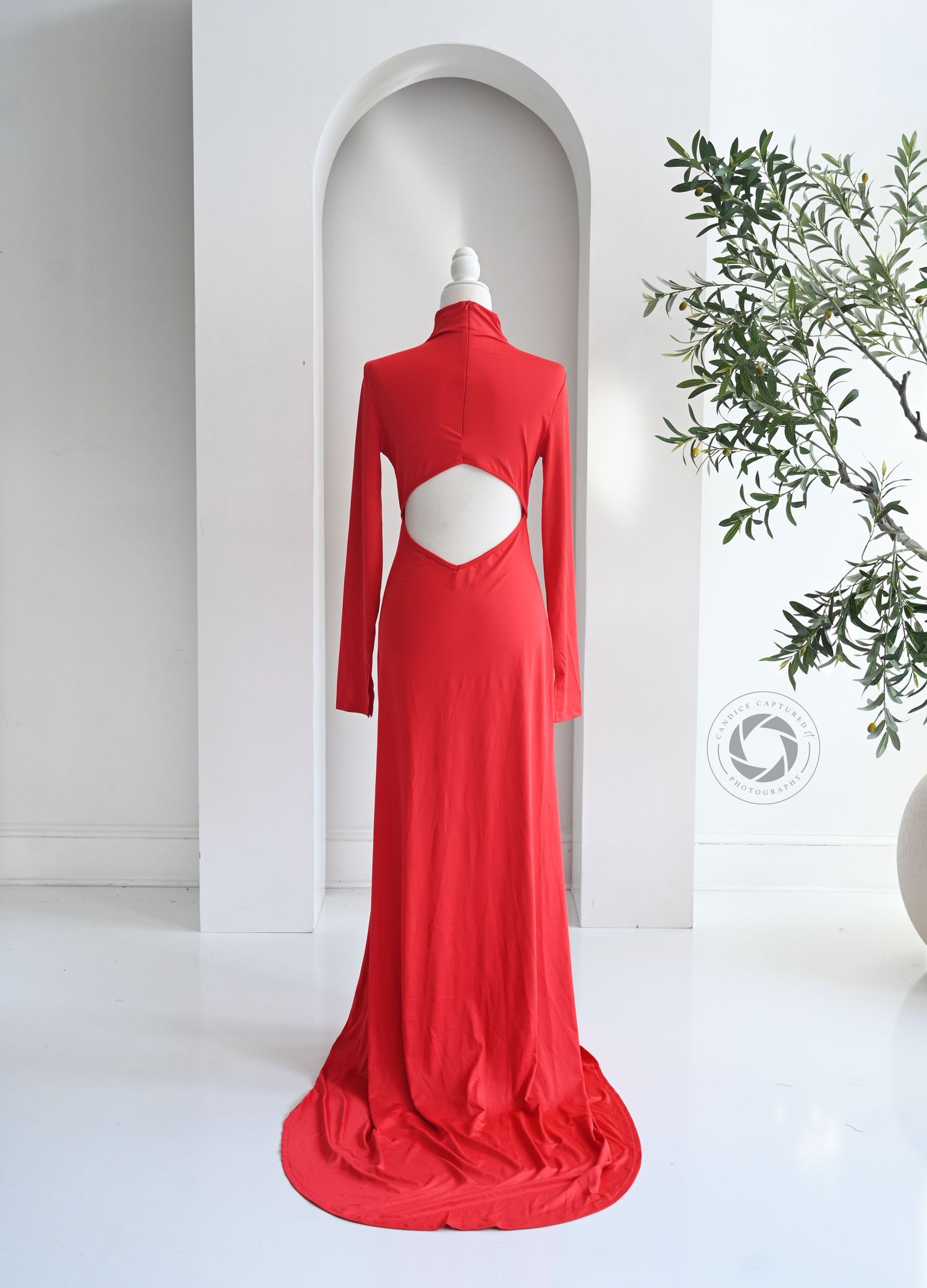 Bright red flowing dress displayed on white mannequin with side ruching detail and long sleeves, shown from multiple angles.