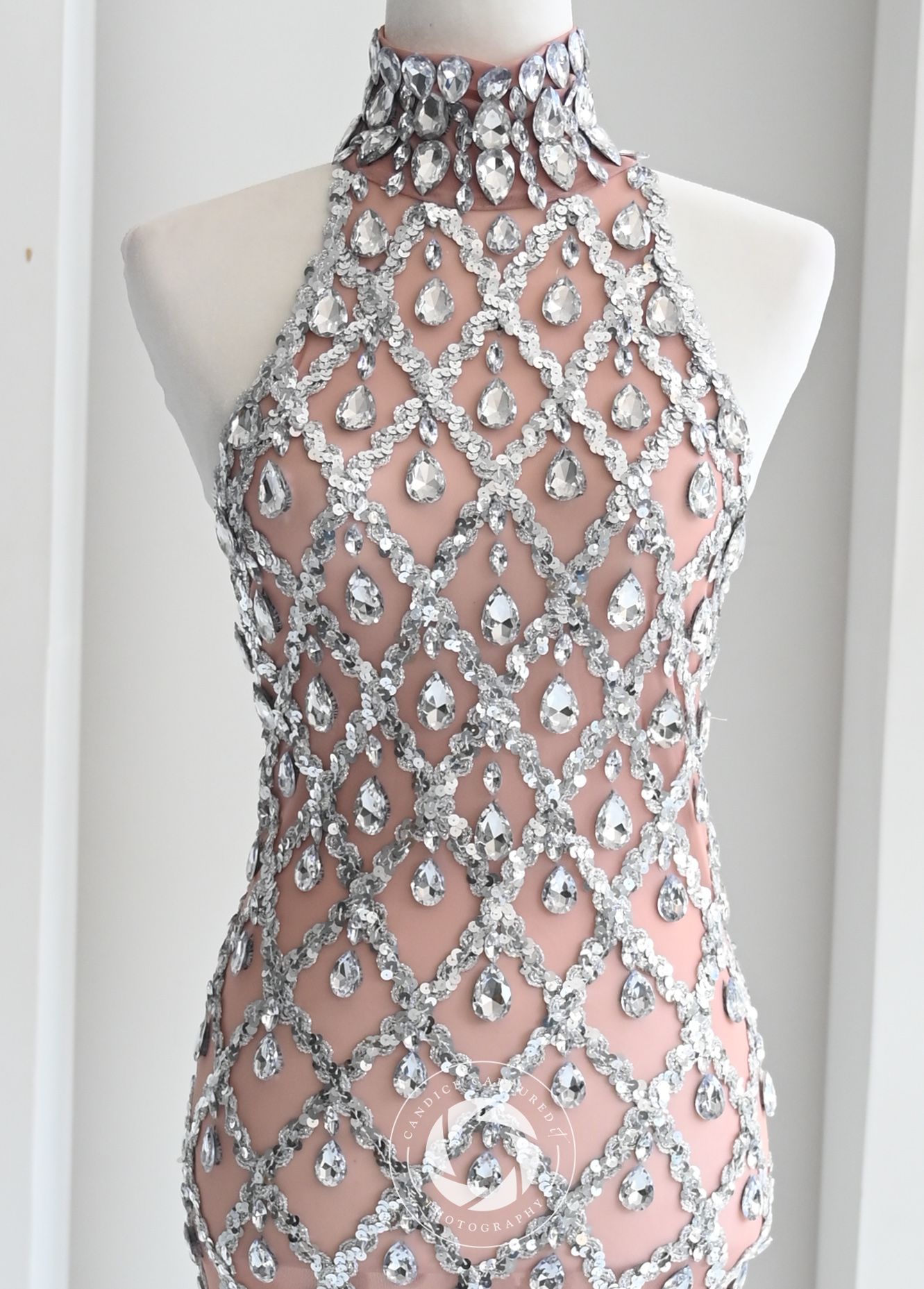 A beaded mesh formal dress with intricate silver embellishments shown from multiple angles on a white mannequin.