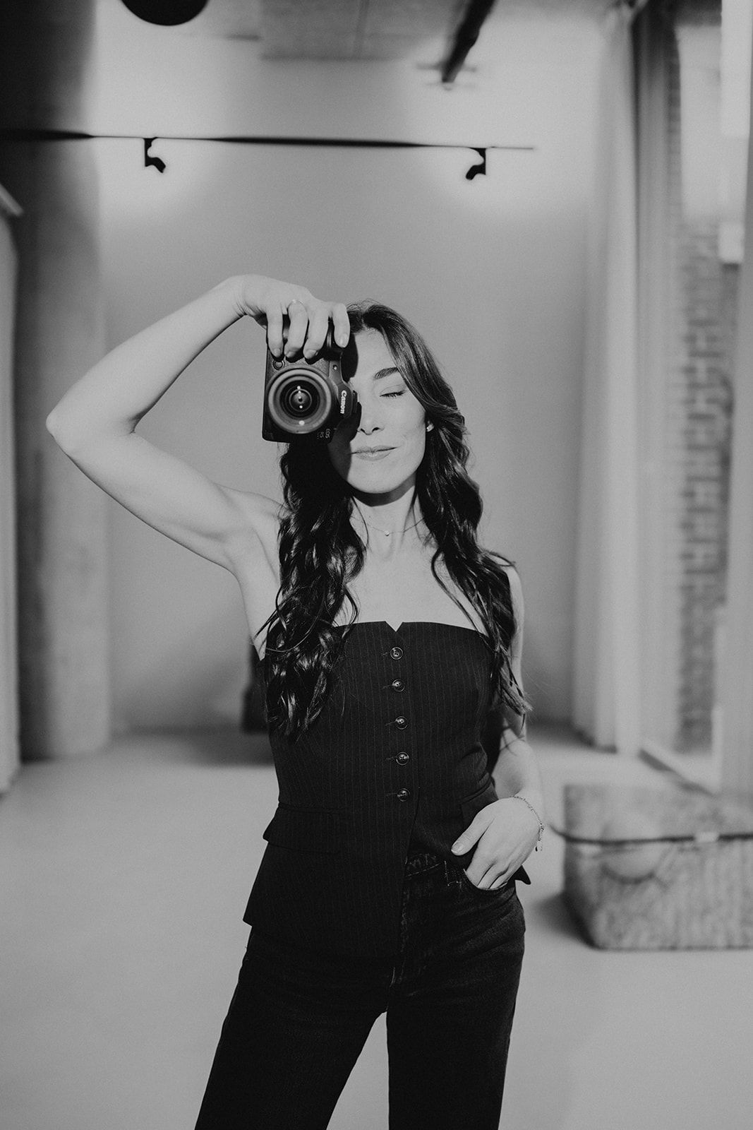 Black and white studio photography scene with minimal industrial decor.