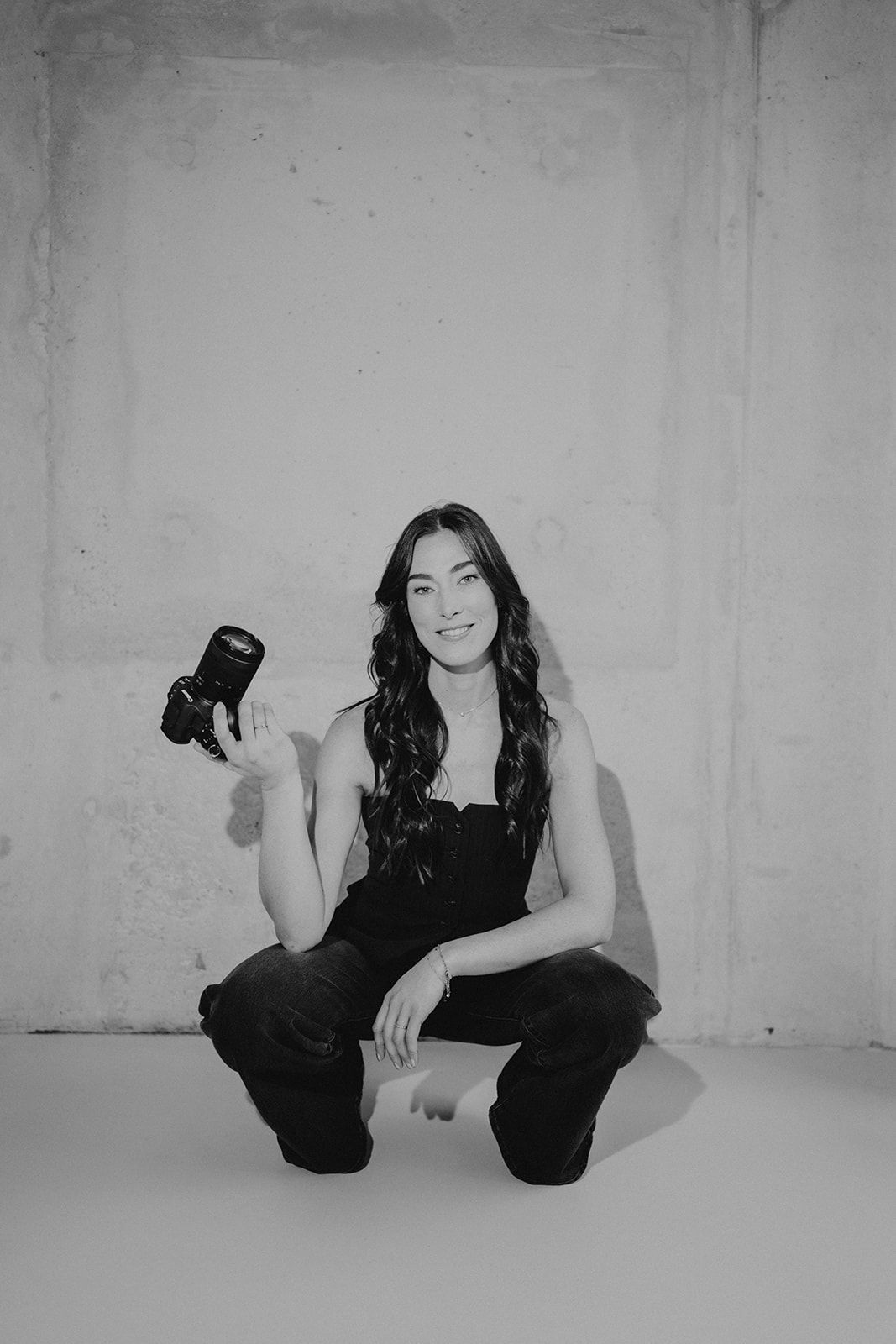 Black and white photo series showing artistic poses against a white studio background.