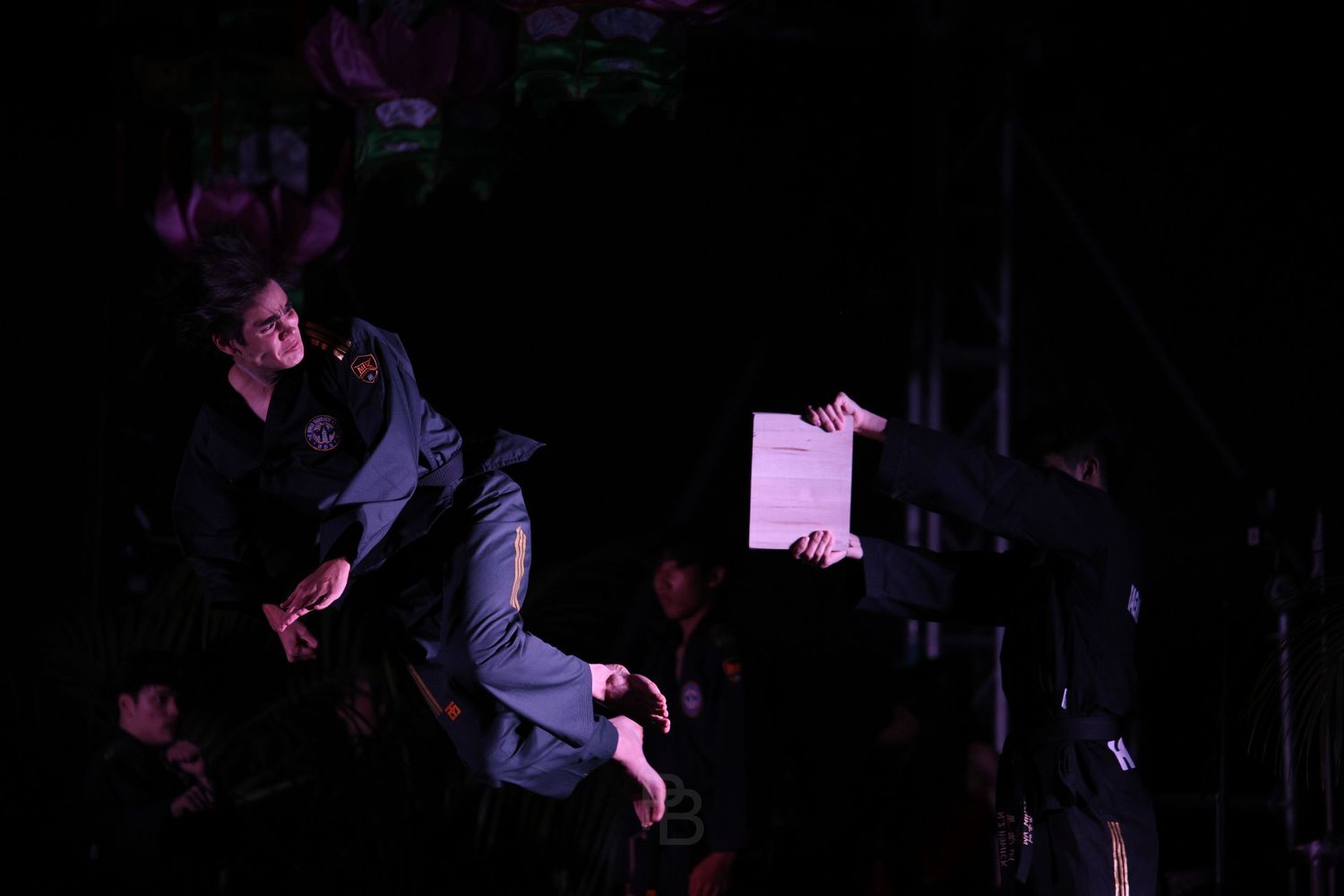 A sequence of six dark silhouettes against a black background shows a person performing a falling motion.