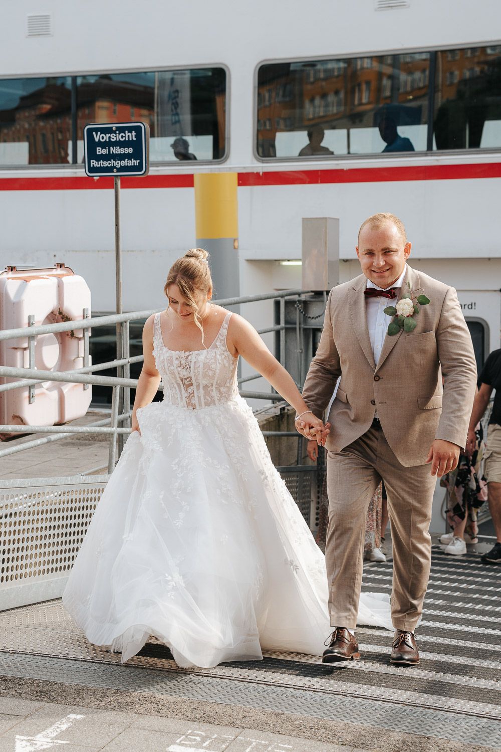A bride in white dress and groom in tan suit playfully pose in a sequence of candid moments on a bright terrace.