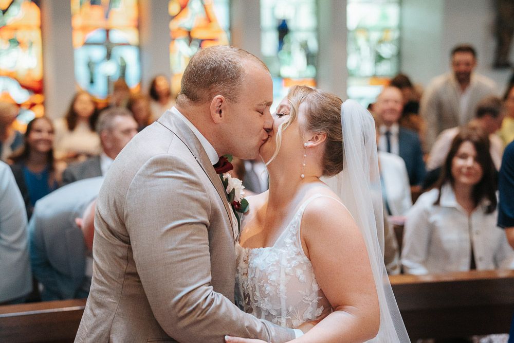 Newlywed couple sharing their first dance together at an elegant indoor wedding reception.