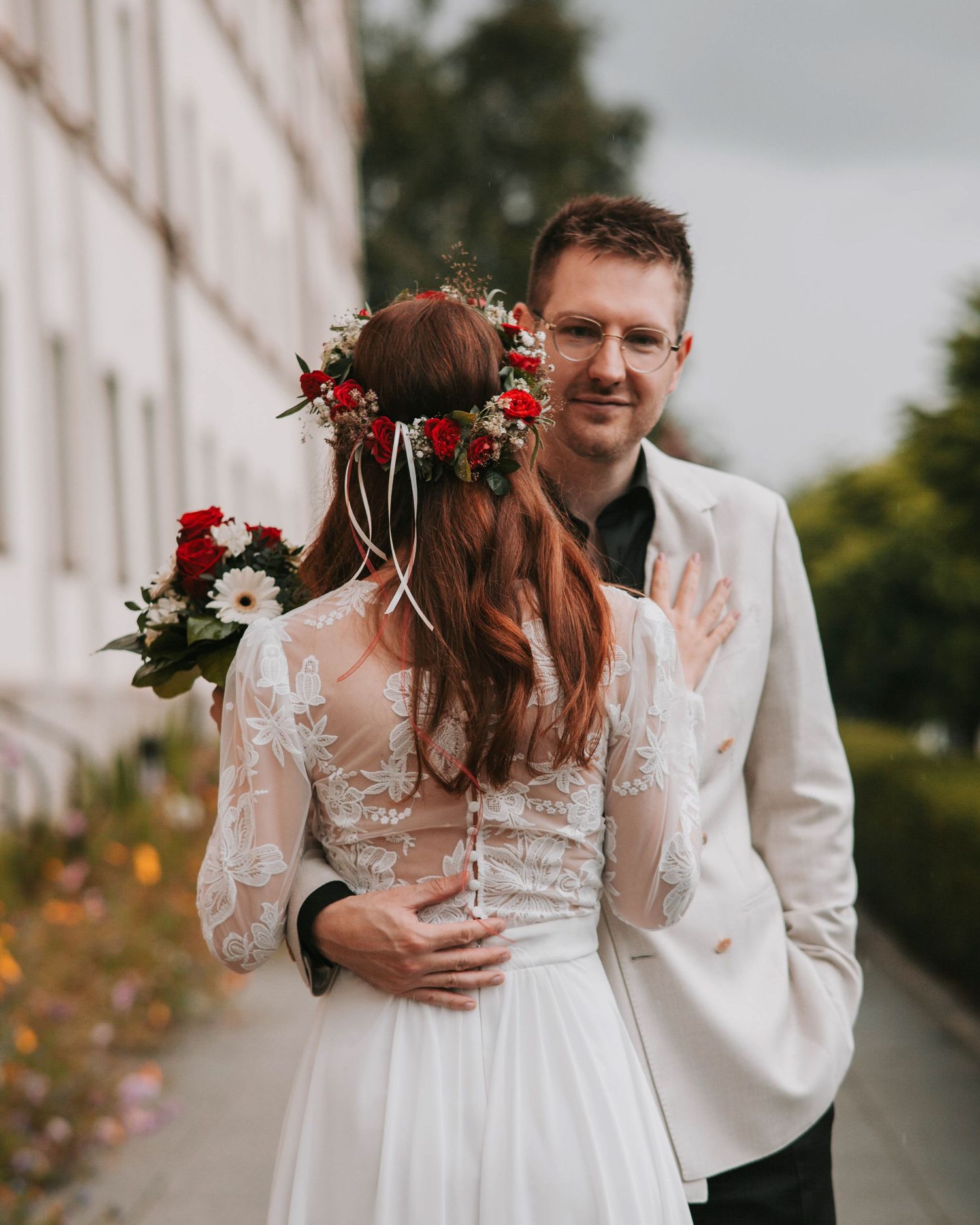 Intimate wedding couple photos taken on a city street with white lace dress and soft romantic poses.