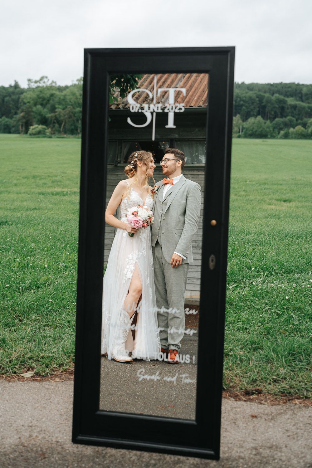 A series of black frames showing a romantic outdoor photo session with a couple posed together in a green meadow setting.