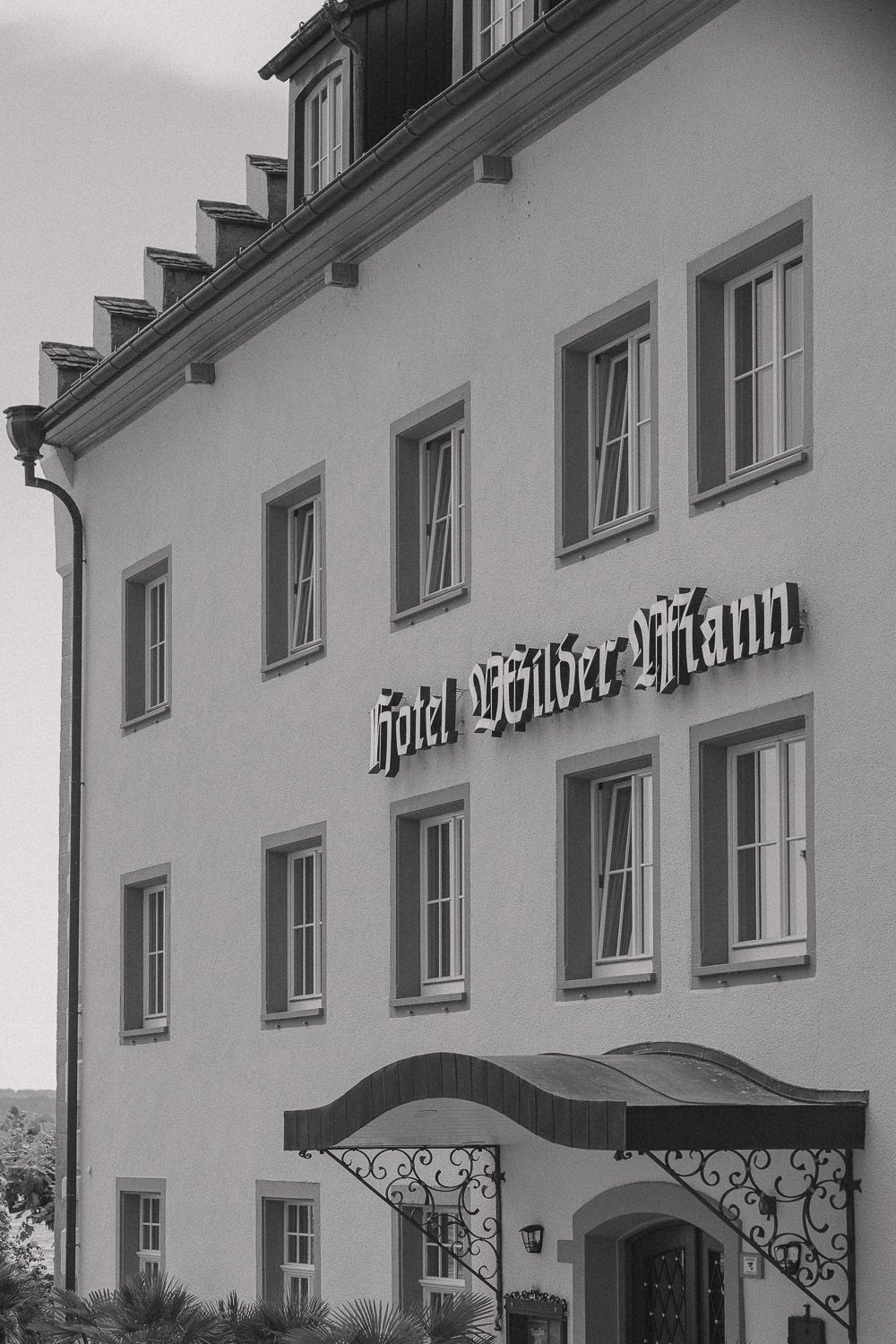 Exterior view of Hotel Bettmer-Hof building with white walls and traditional German architecture.