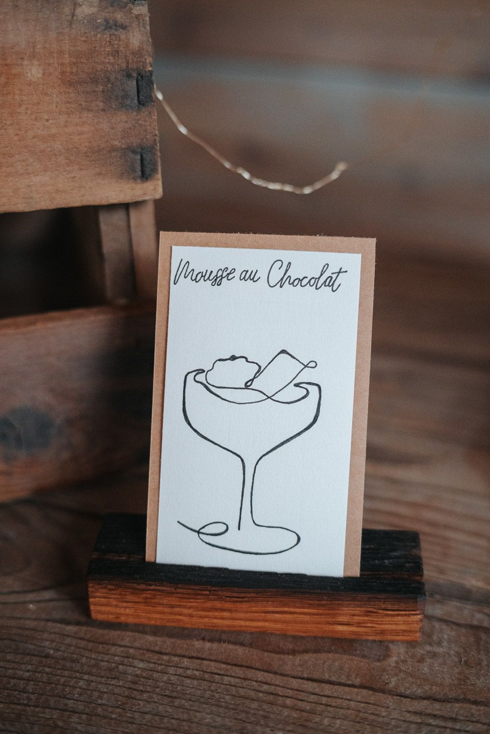 A series of simple line drawings of a bird in flight on small paper cards placed against a wooden surface.