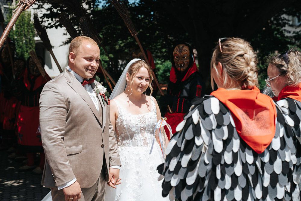 Wedding guests celebrate and dance together at outdoor reception gathering during daytime celebration event.