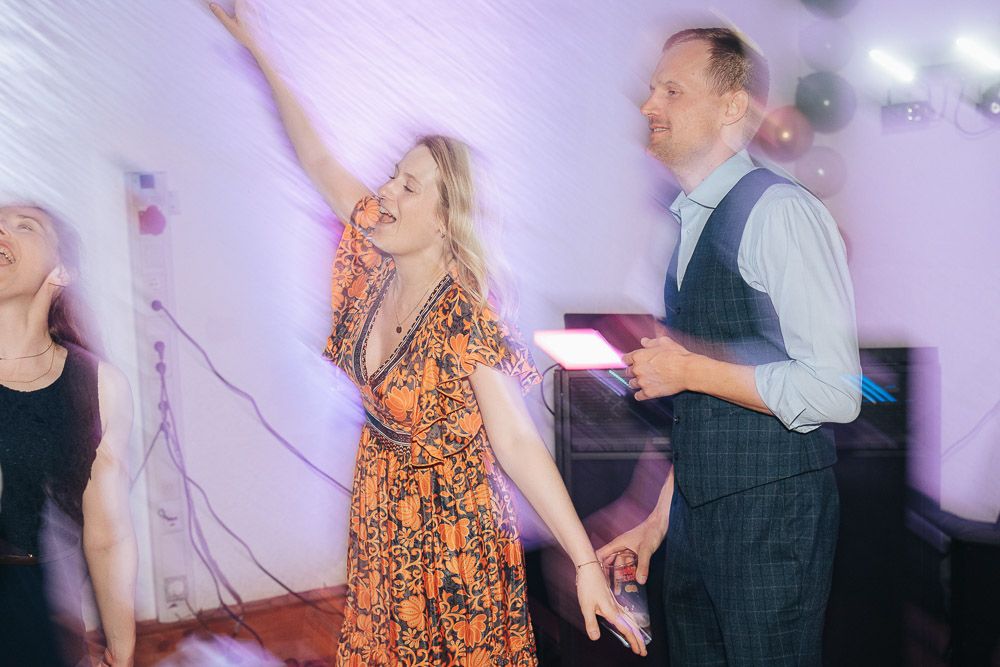 People dancing in a dreamy pink and purple lit room, creating a sequence of fluid movements across multiple frames.