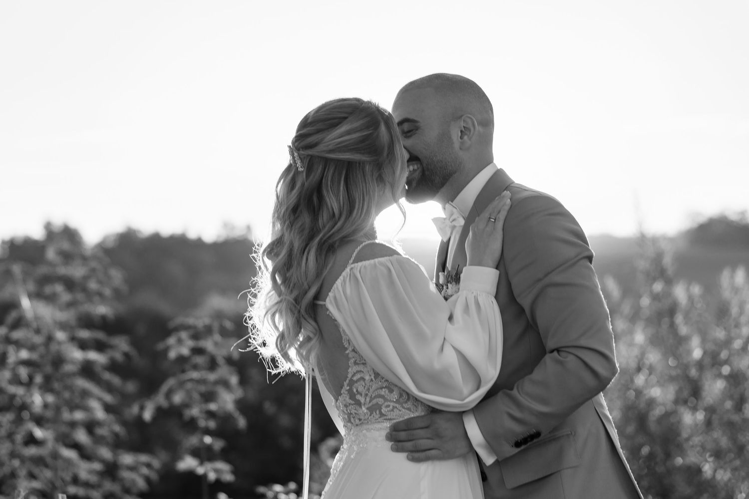 A series of romantic black and white wedding photos showing couples embracing during outdoor ceremonies.