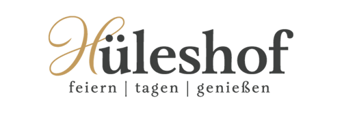 Hüleshof logo with elegant gold script and dark text reading feiern, tagen, genießen on white background.