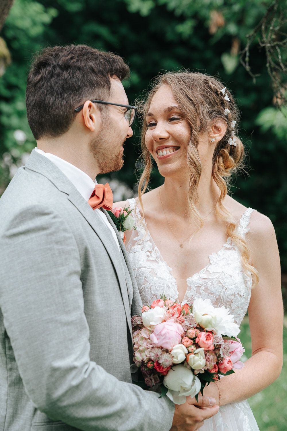 A romantic wedding photo sequence showing tender moments between a bride in lace and groom in gray outdoors.
