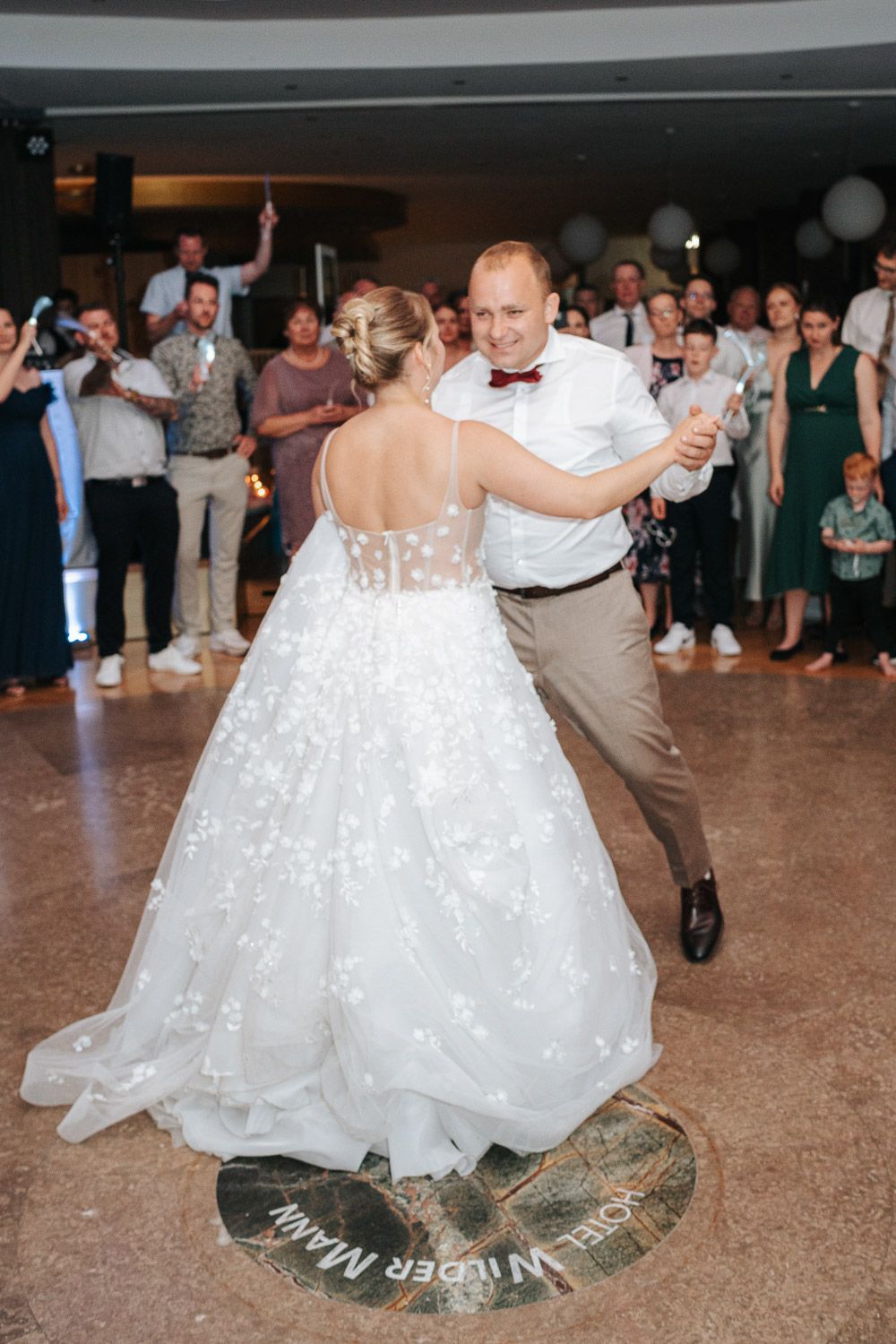 A sequence of dance floor photos showing a bride's white dress swirling elegantly during a traditional first wedding dance.