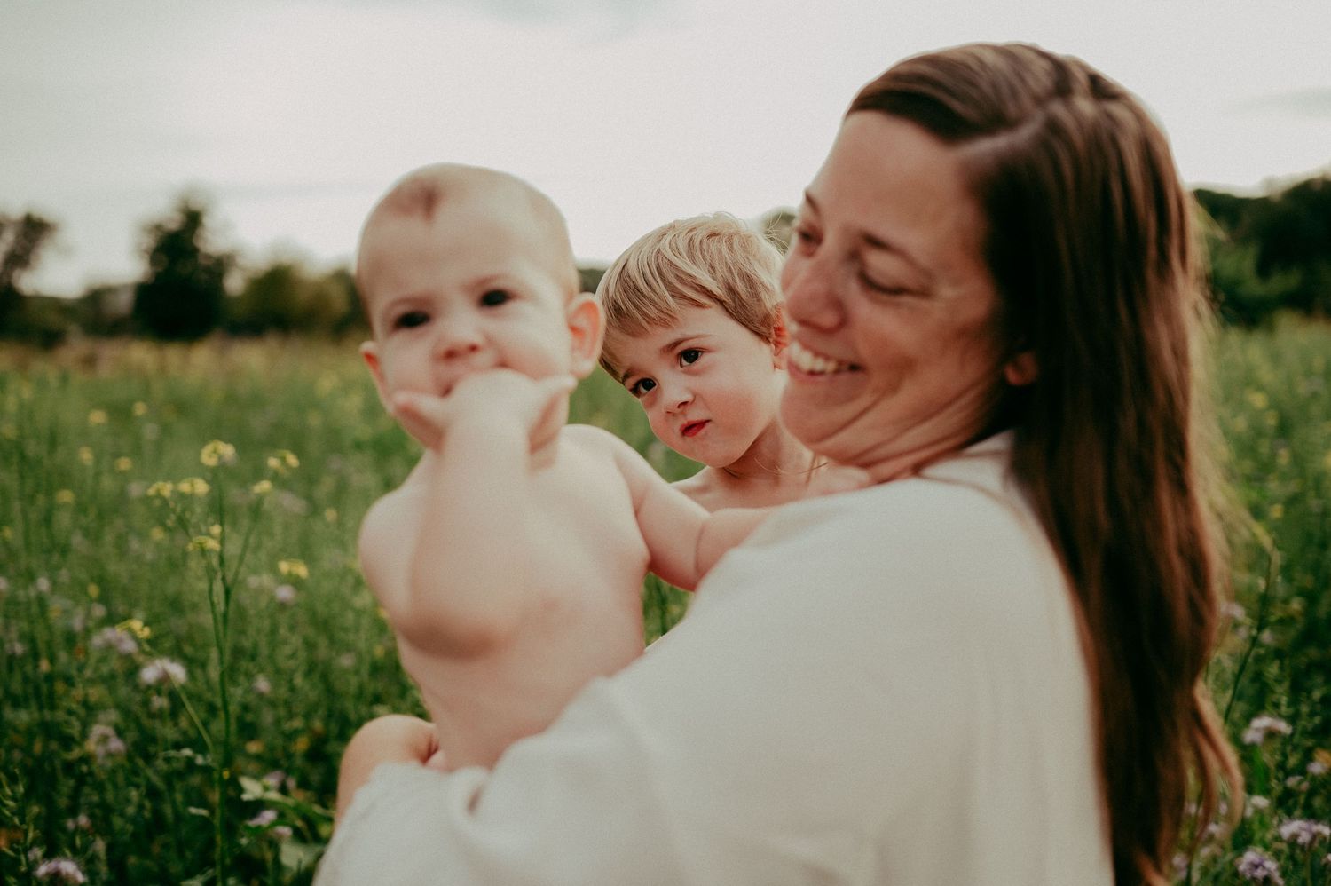 A heartwarming outdoor portrait in a blooming wildflower field.