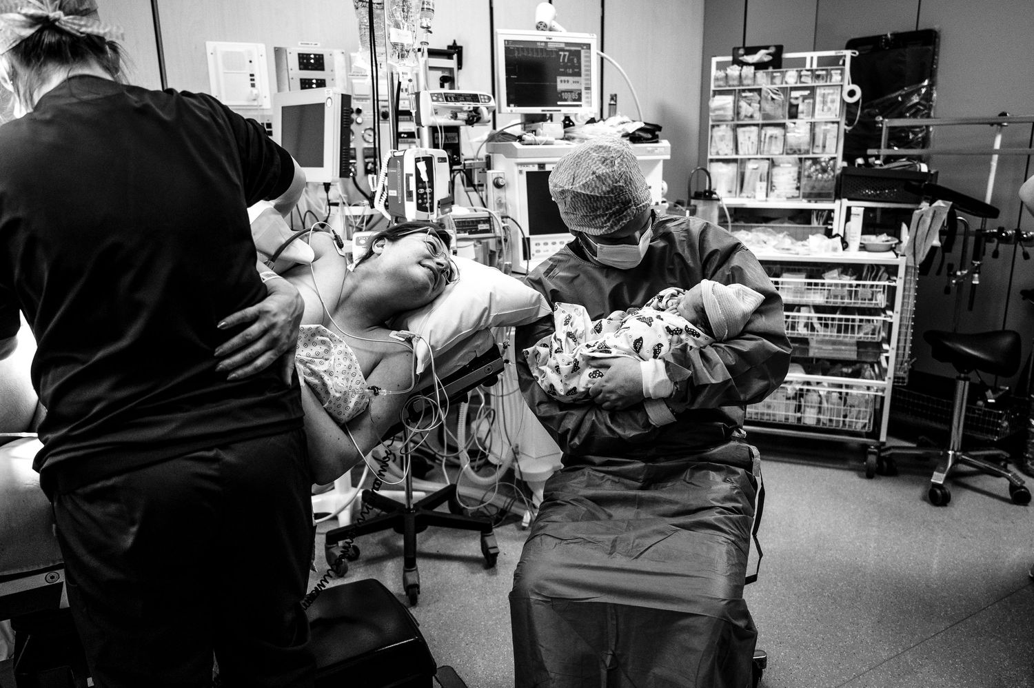 Medical professionals in protective gear work together in a hospital intensive care unit during a healthcare emergency.