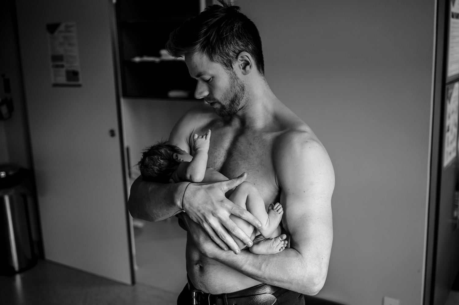 A tender skin-to-skin bonding moment with a newborn in a hospital setting.