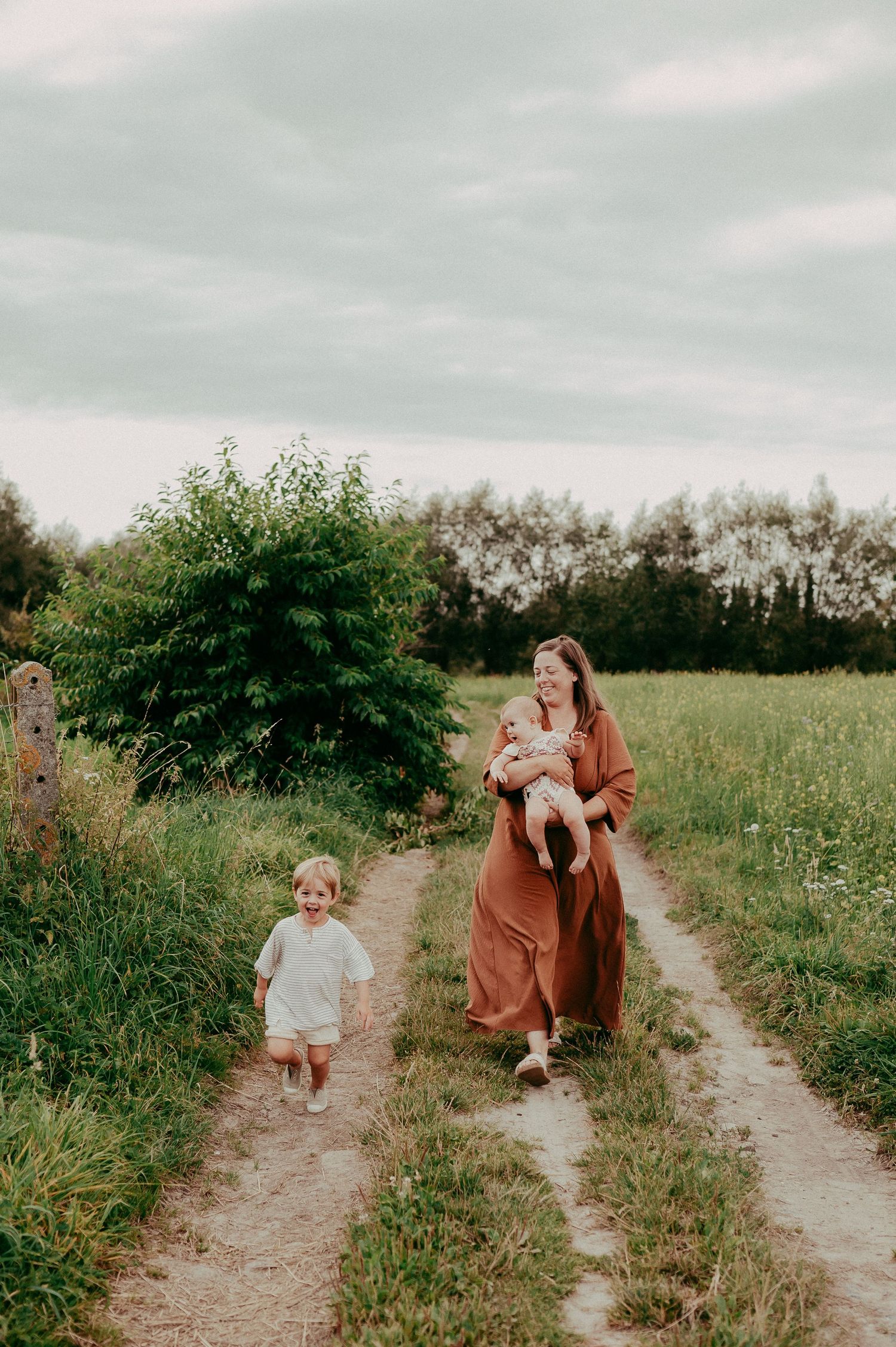 A peaceful walk along a rural dirt path surrounded by lush summer greenery.