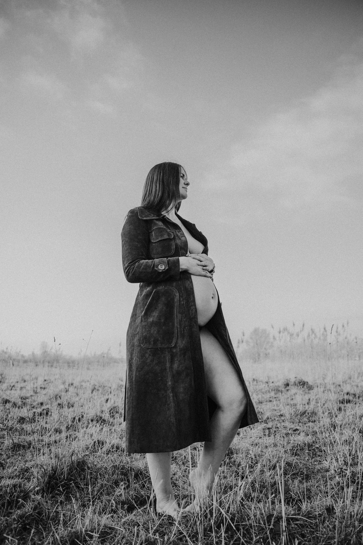 Black and white artistic photo series showing a person in a dark coat standing alone in a misty field.