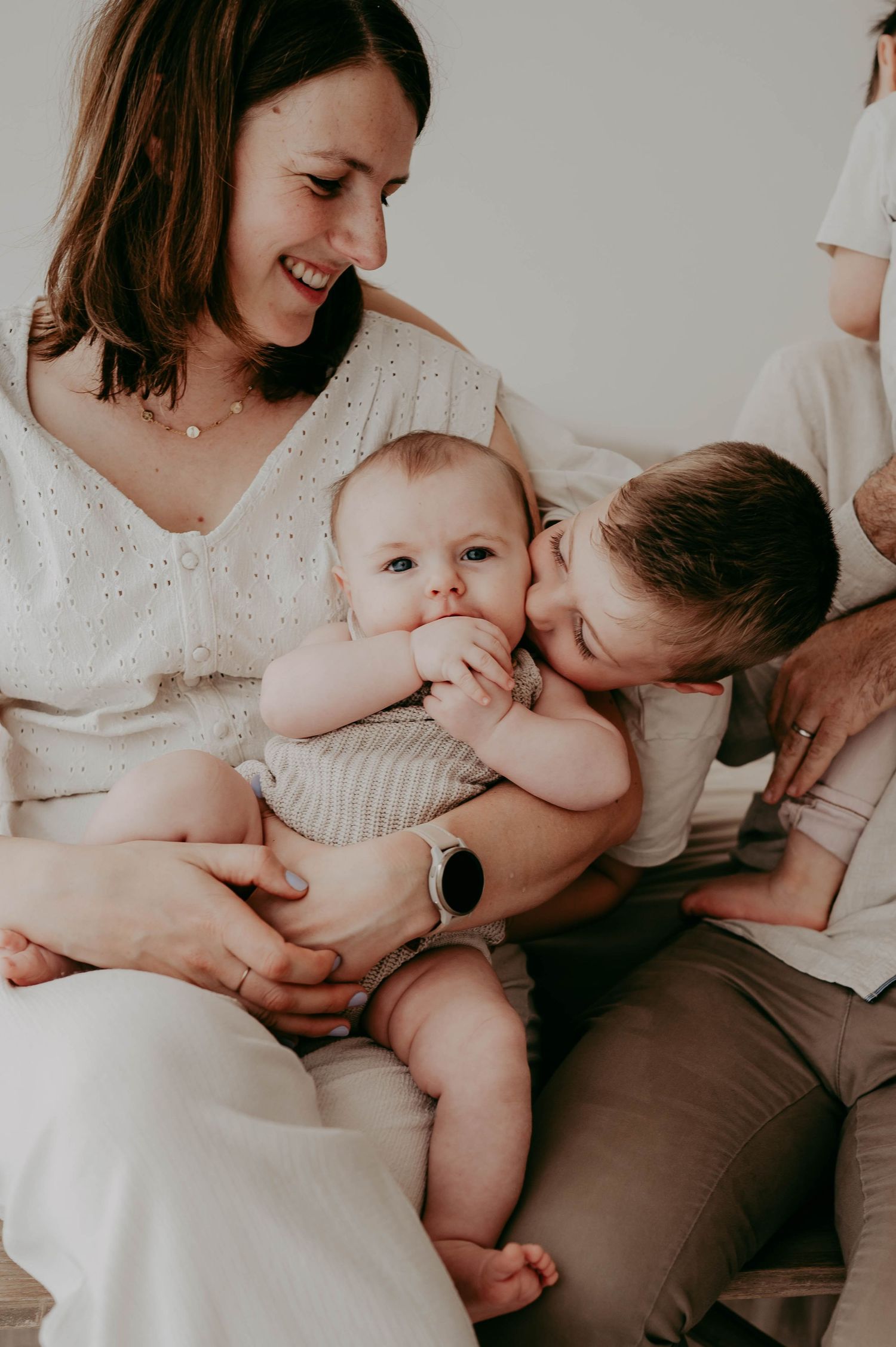 An intimate indoor family moment showing tender interaction between parents and baby.