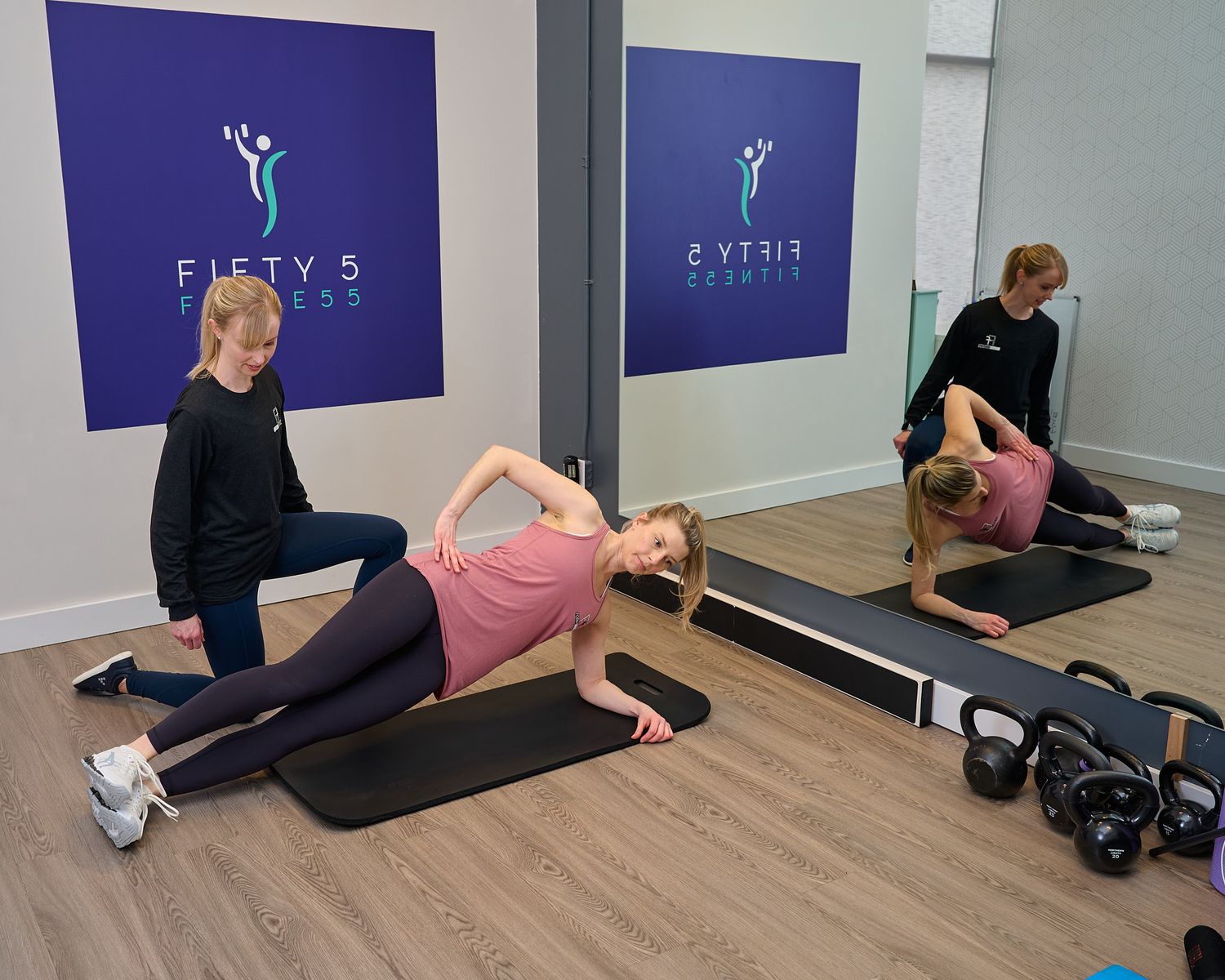 A sequence of stretching exercises being performed on a yoga mat against a blue wall in a fitness studio.