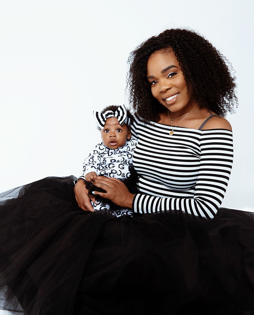 Mother and baby in coordinated black and white striped outfits with tulle skirt.