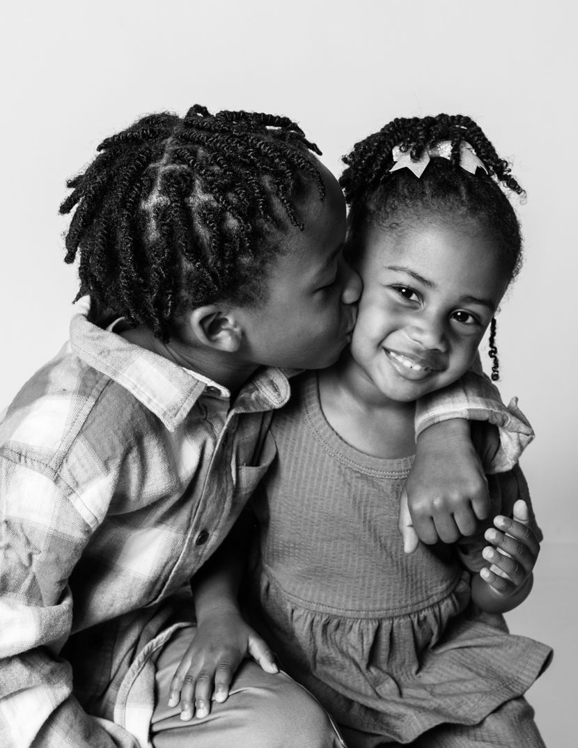Black and white photographs depicting sweet sibling interaction and embraces.