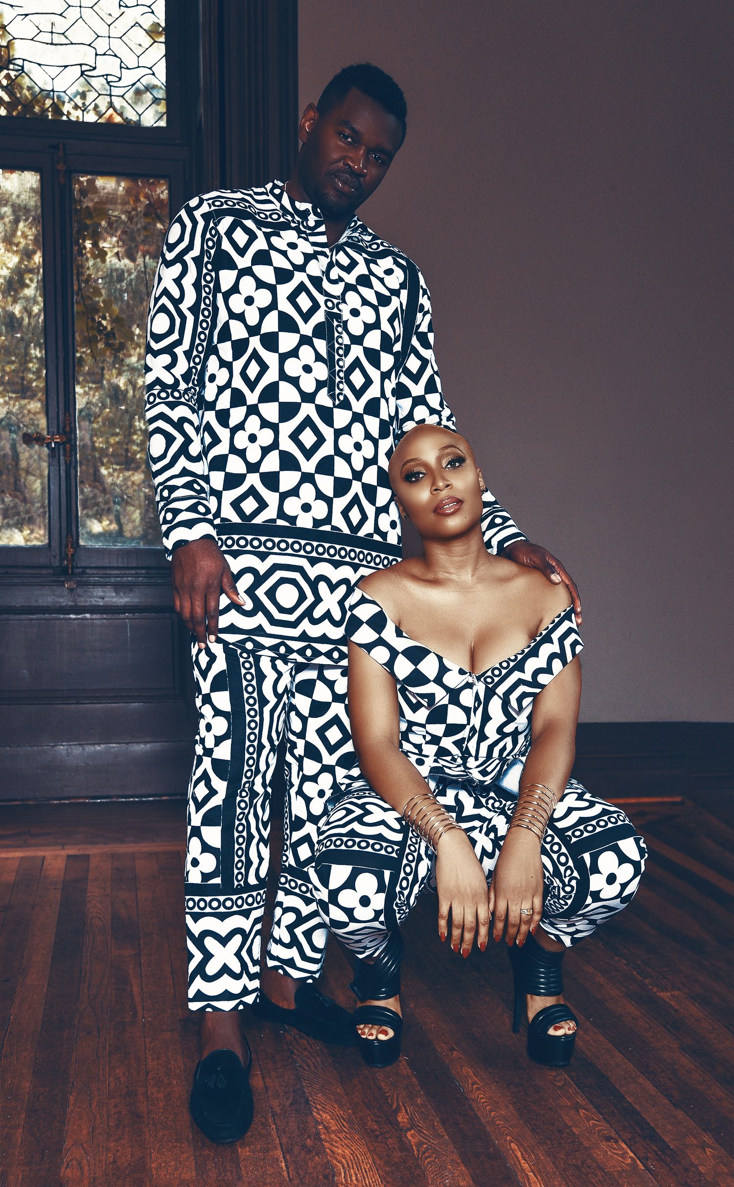 Fashion photo series showing model in black and white geometric print dress posing on wooden floor in moody lighting.
