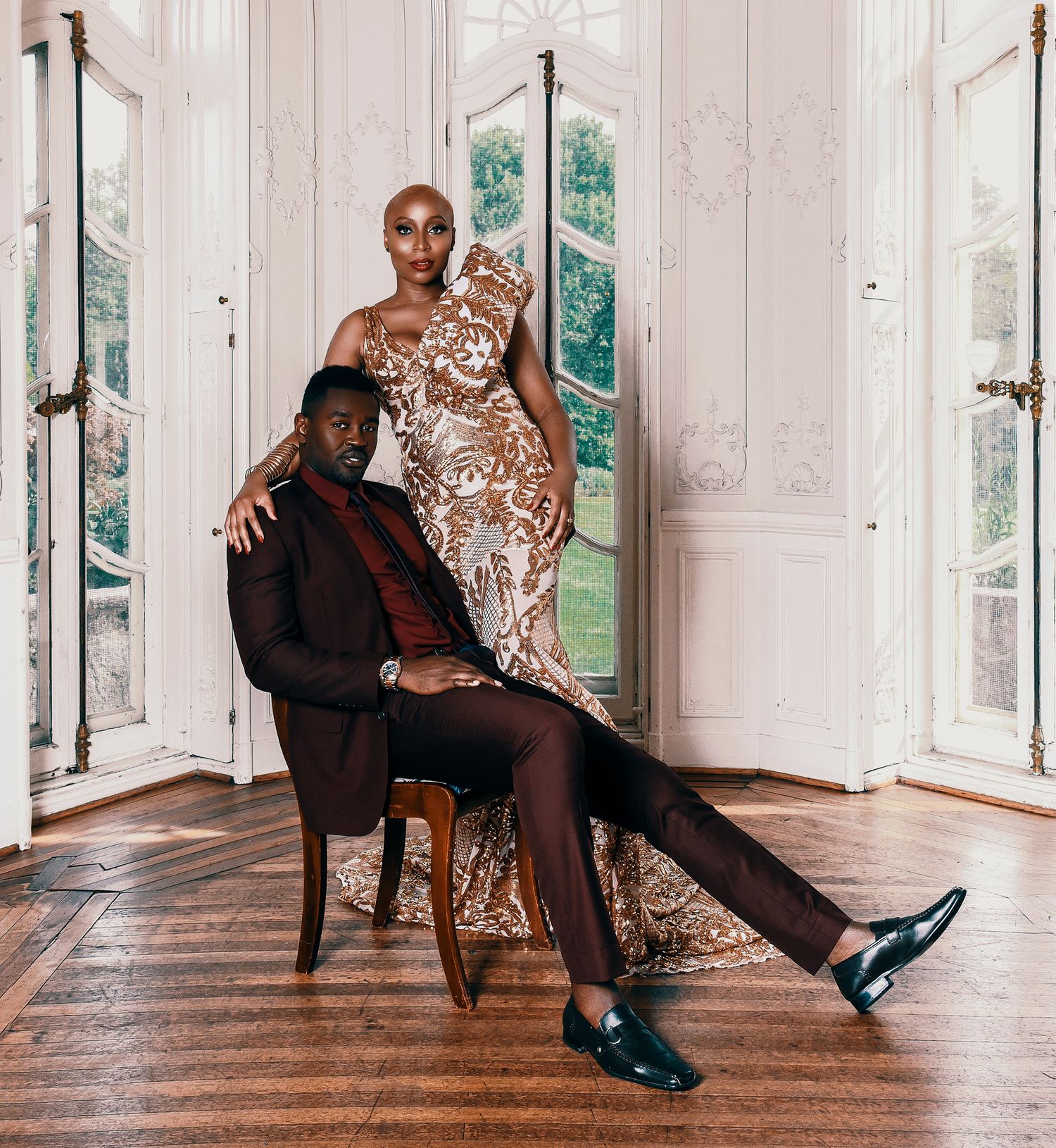 Artistic fashion photo series showing model in brown outfit and blue heels posing on wooden floor in sunlit white room.