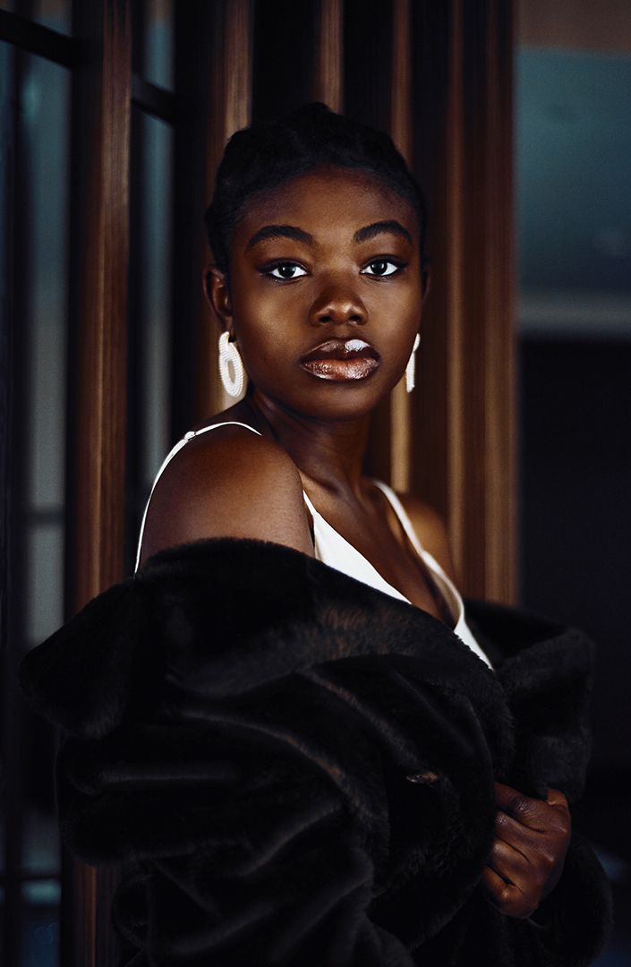Dramatic portrait series showing someone in elegant black attire against dark wood paneling.