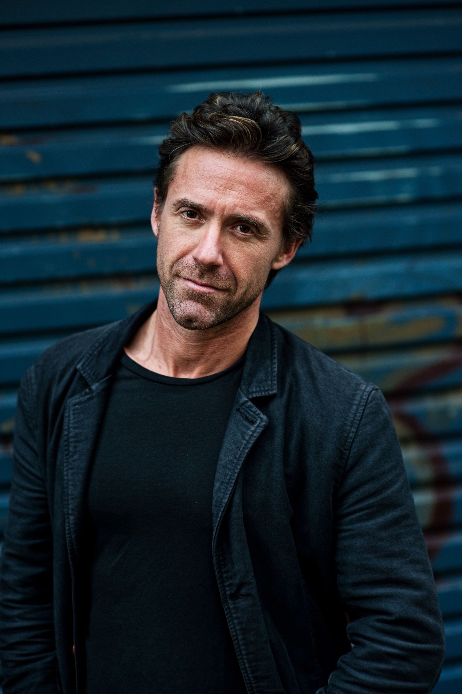 A series of close-up profile portraits showing a person in a black jacket against a dark blue background.