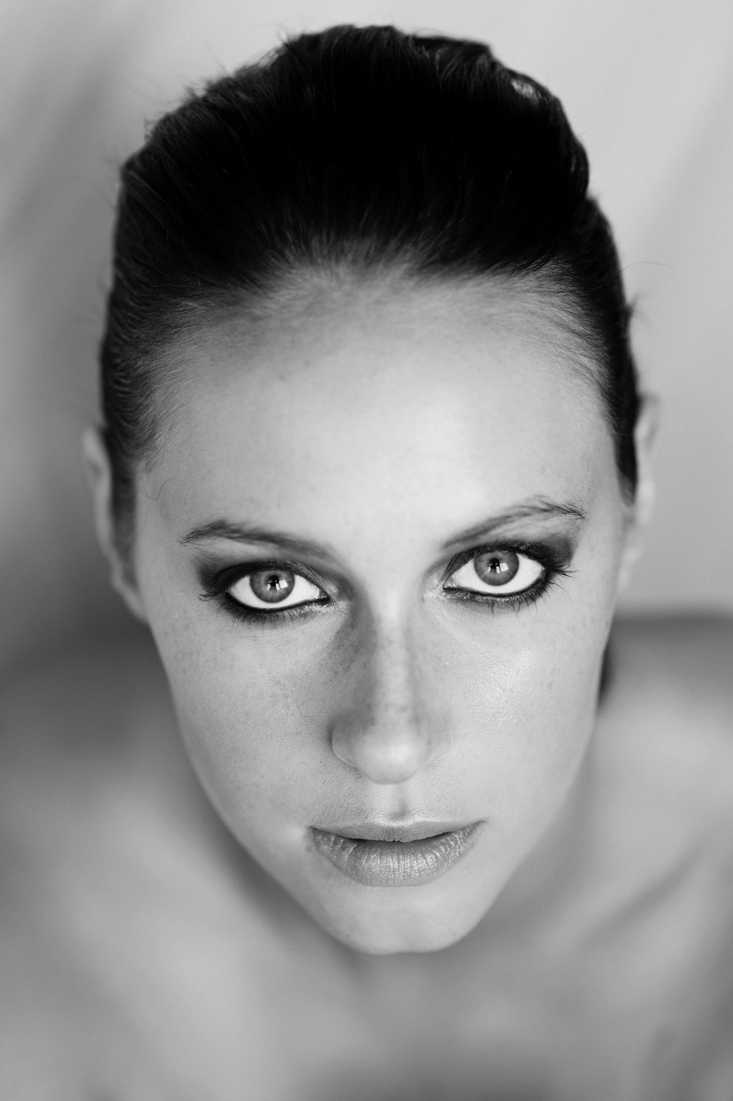 Dramatic black and white portrait series highlighting intense gaze and facial features.