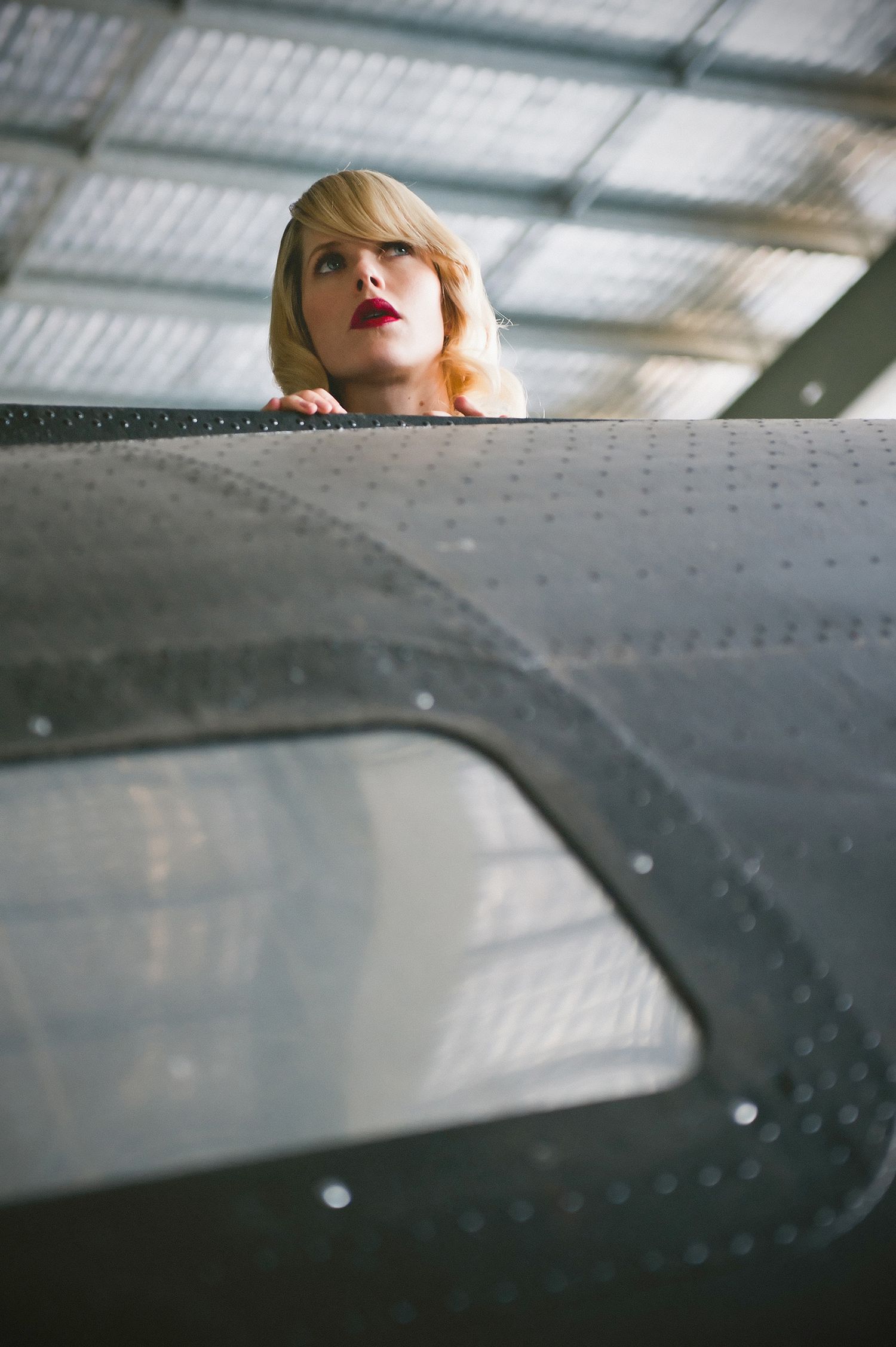 Artistic shots showing glimpses against an industrial metal surface with rivets.