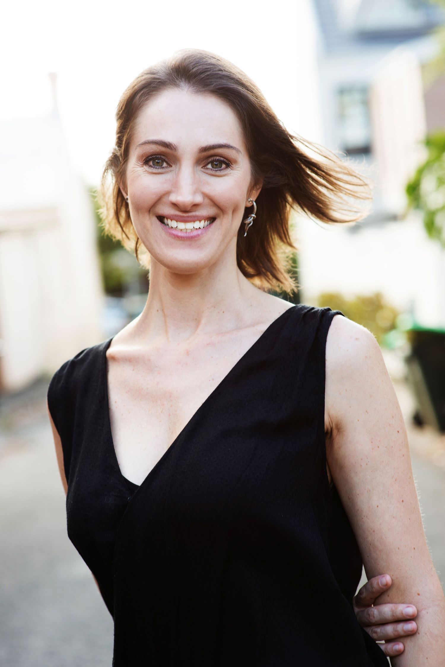 Outdoor portrait series in black sleeveless top with natural lighting.