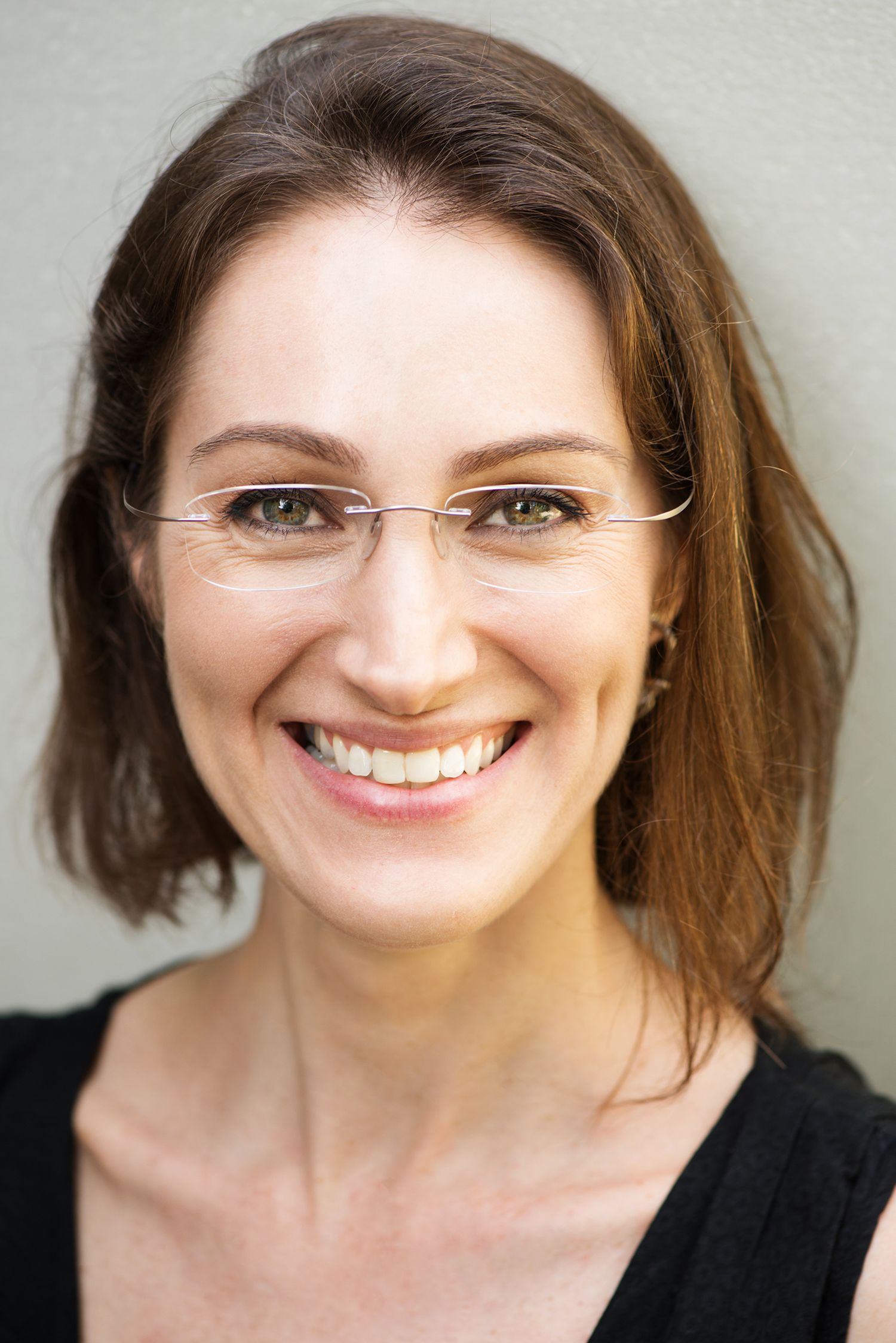 Series of headshots showing genuine smile and glasses against light background.