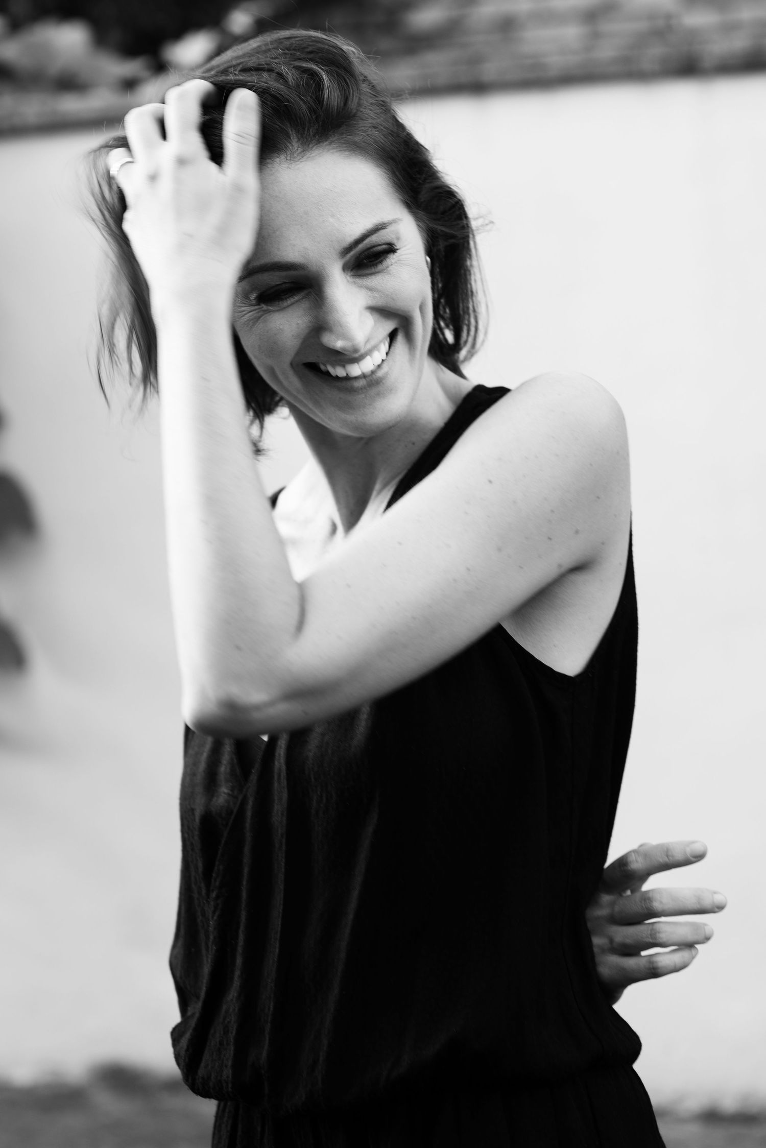 Black and white candid portrait series showing joyful, natural expressions.