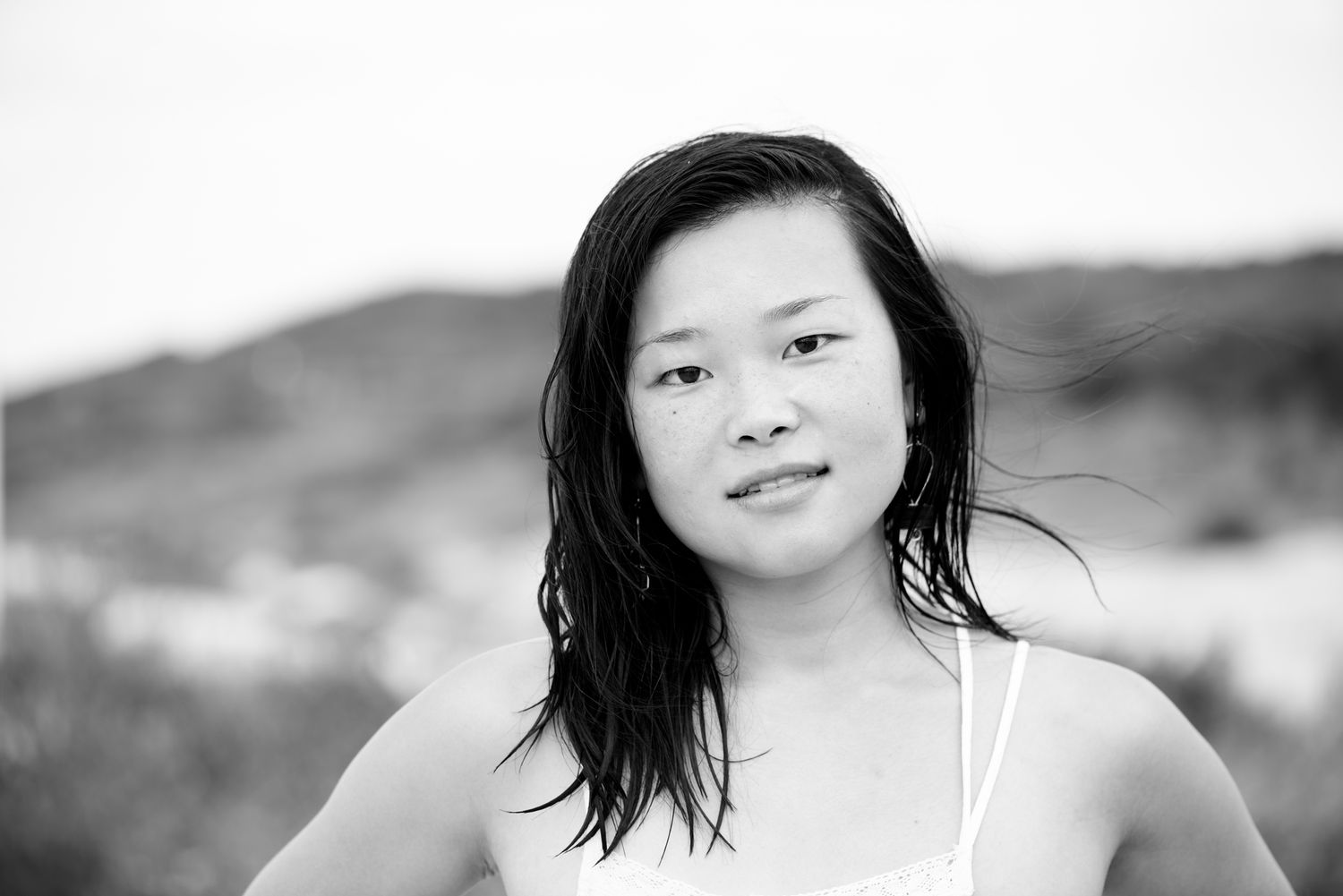 Black and white portrait series showing candid expressions and movement outdoors.