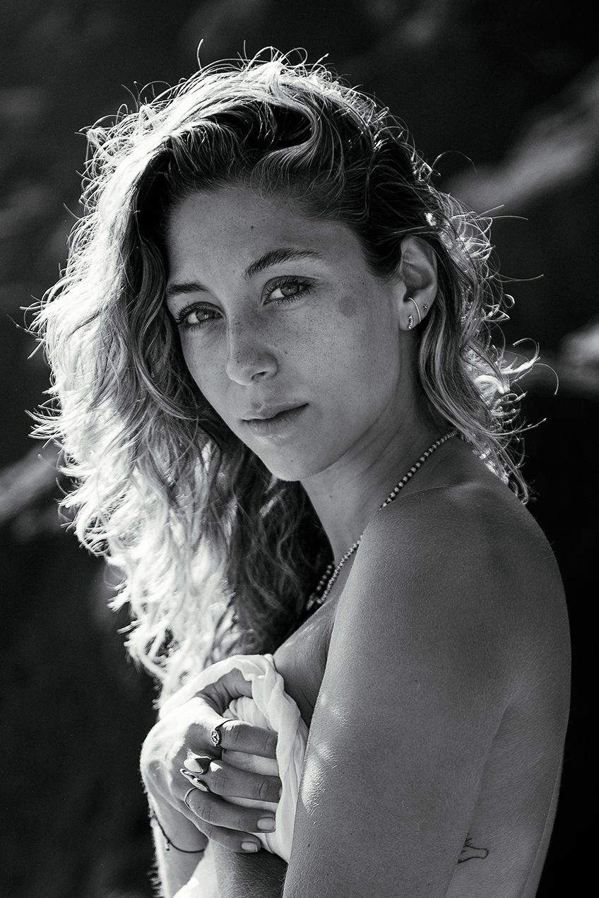 Black and white artistic portrait series showing a figure with windswept hair in dramatic lighting and poses.