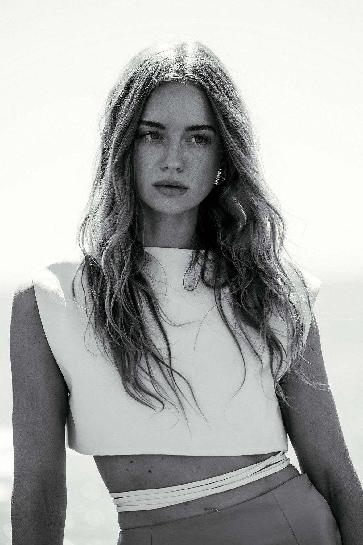 High contrast black and white portraits of model in white asymmetrical top.