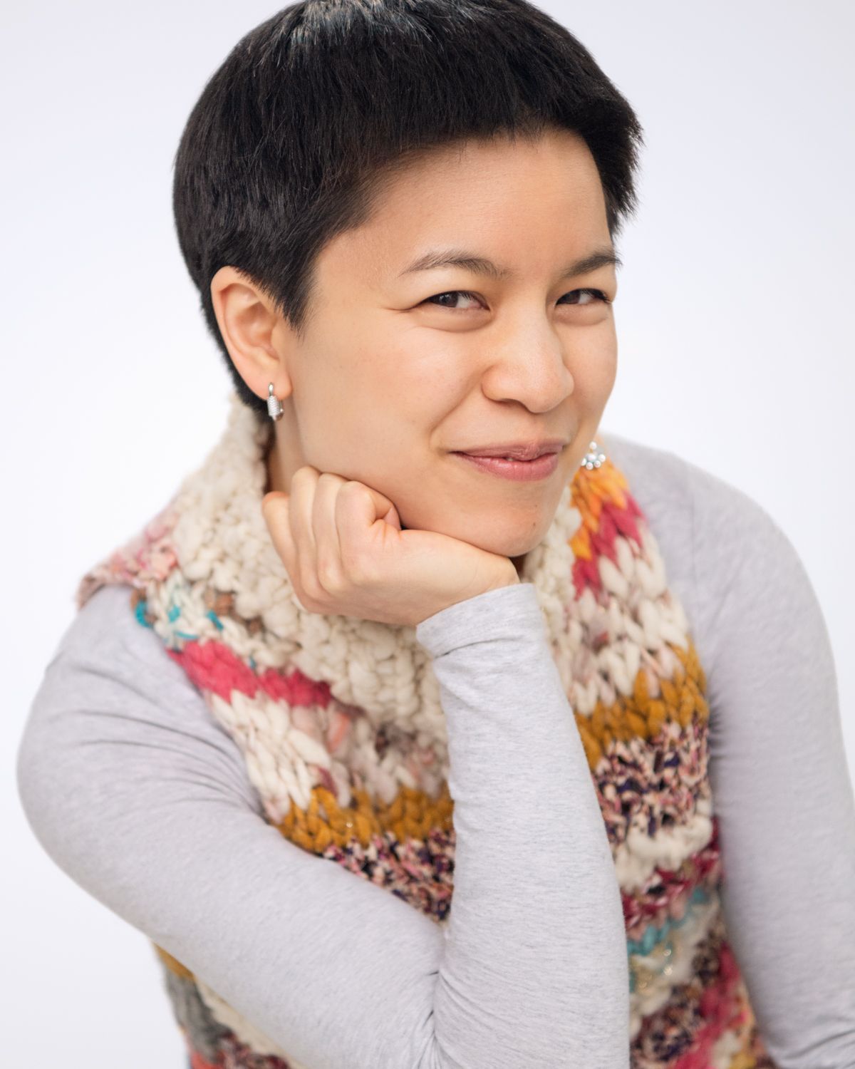 Expressive headshots with cozy winter scarf against white background.