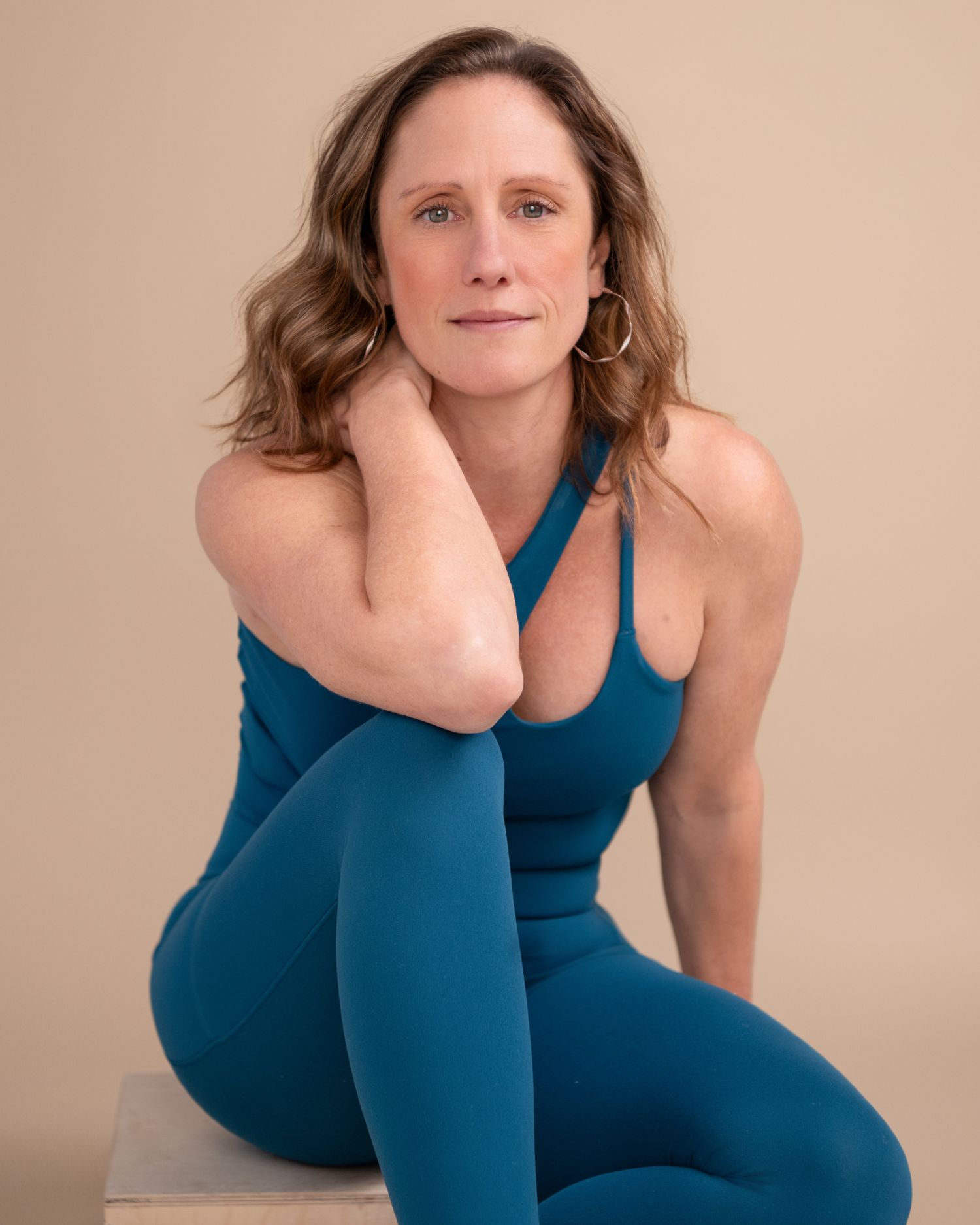Athletic poses in blue workout attire against neutral background.