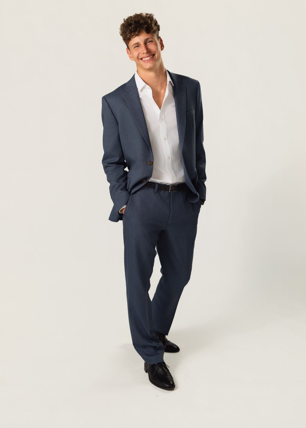 Professional business portraits in a navy suit and white shirt from various angles.