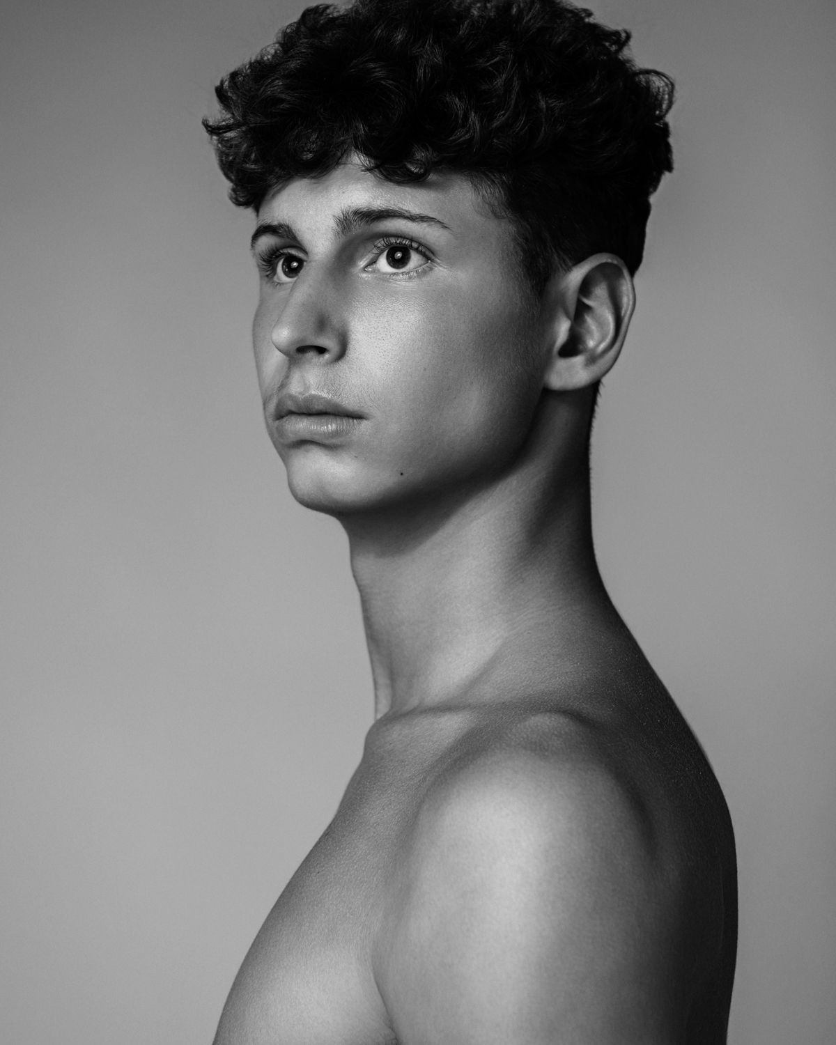 Dramatic black and white studio portraits showing artistic angles and lighting.
