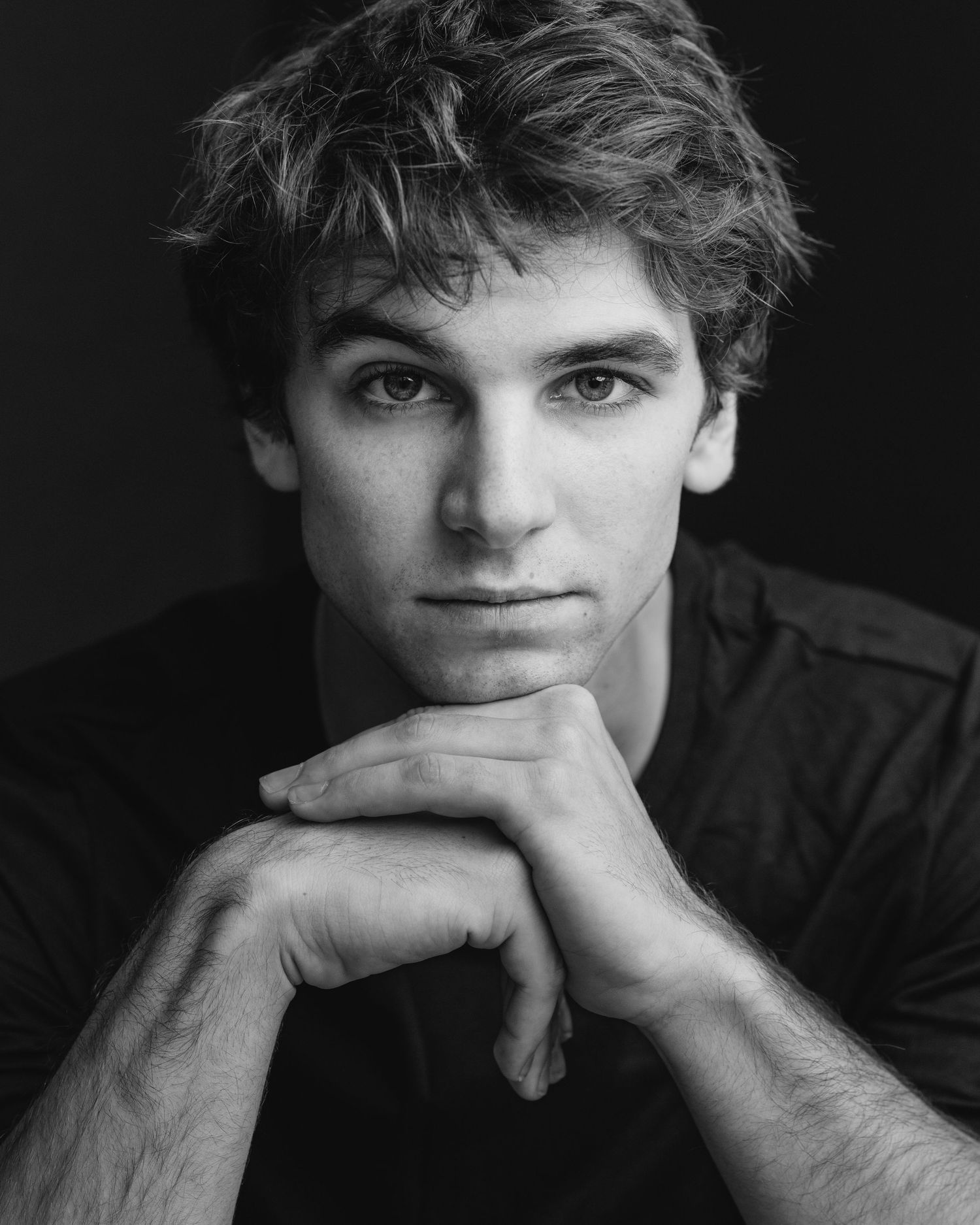 Black and white portrait series with contemplative poses.