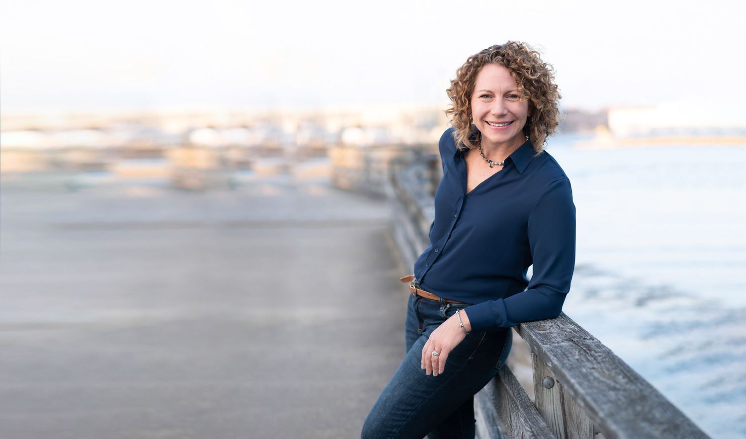 A series of professional headshots and lifestyle photos of a person in business attire against coastal backgrounds.