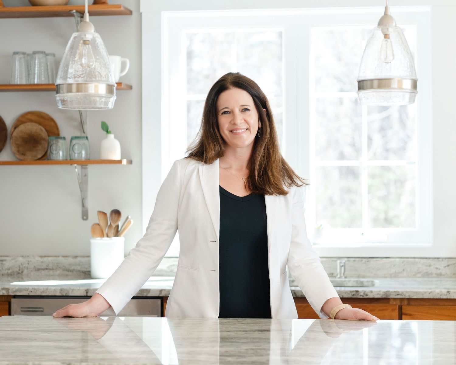 A collection of bright, airy interior photos showing kitchen and home office spaces with white decor and wooden accents in Stratham, NH