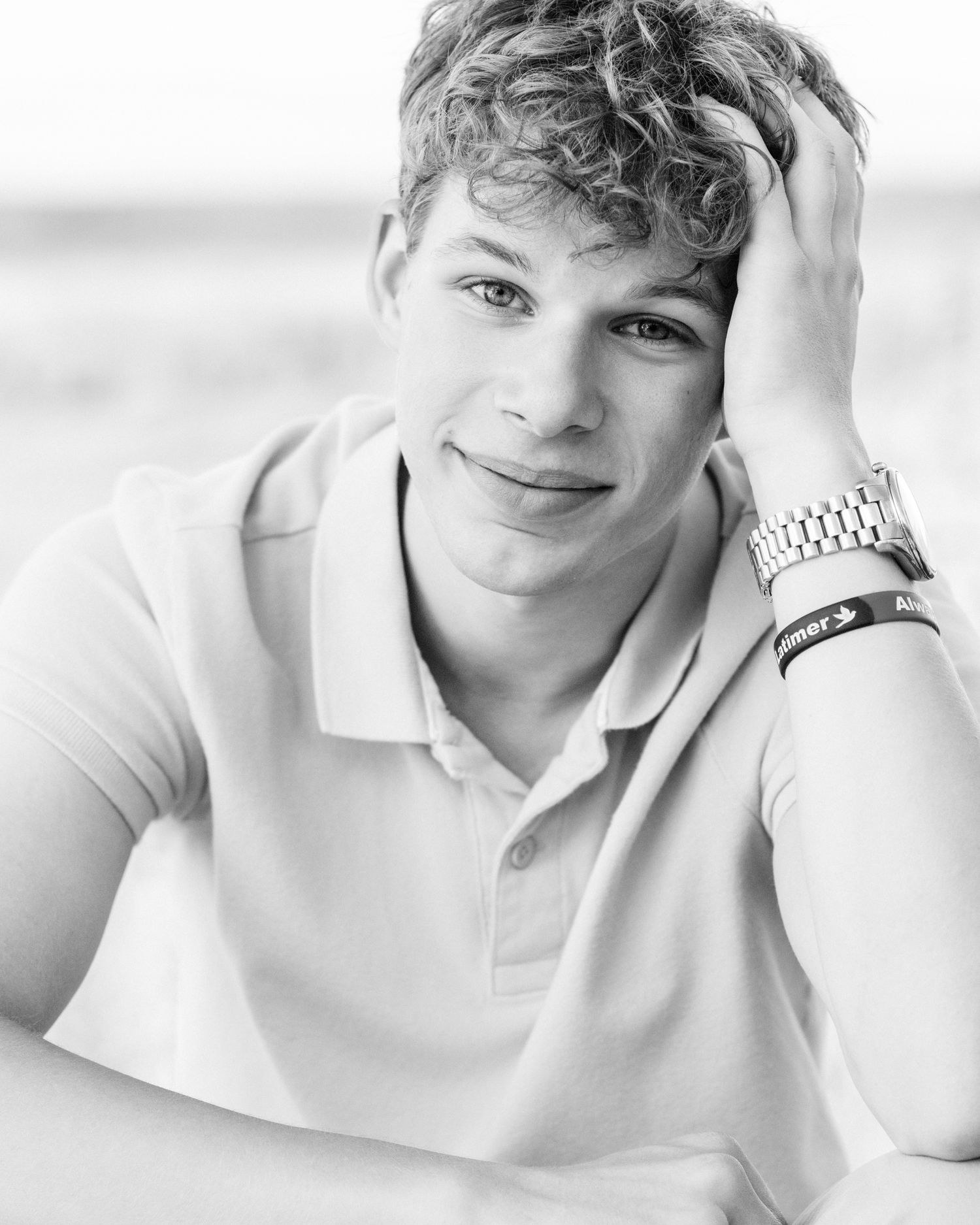 Close-up portrait series showing relaxed poses in white polo shirt.