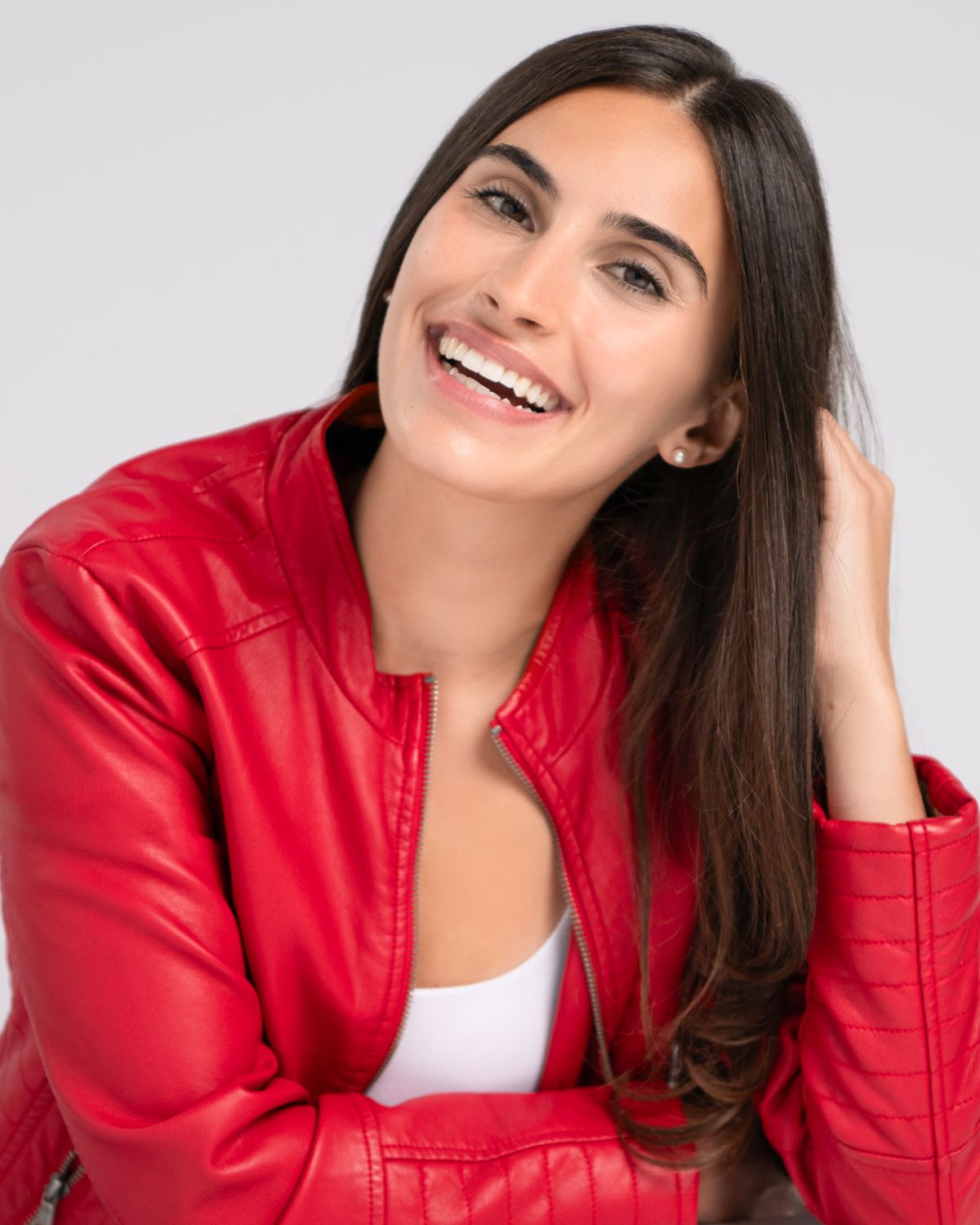 Portrait series showing joyful expressions while wearing a bright red jacket.
