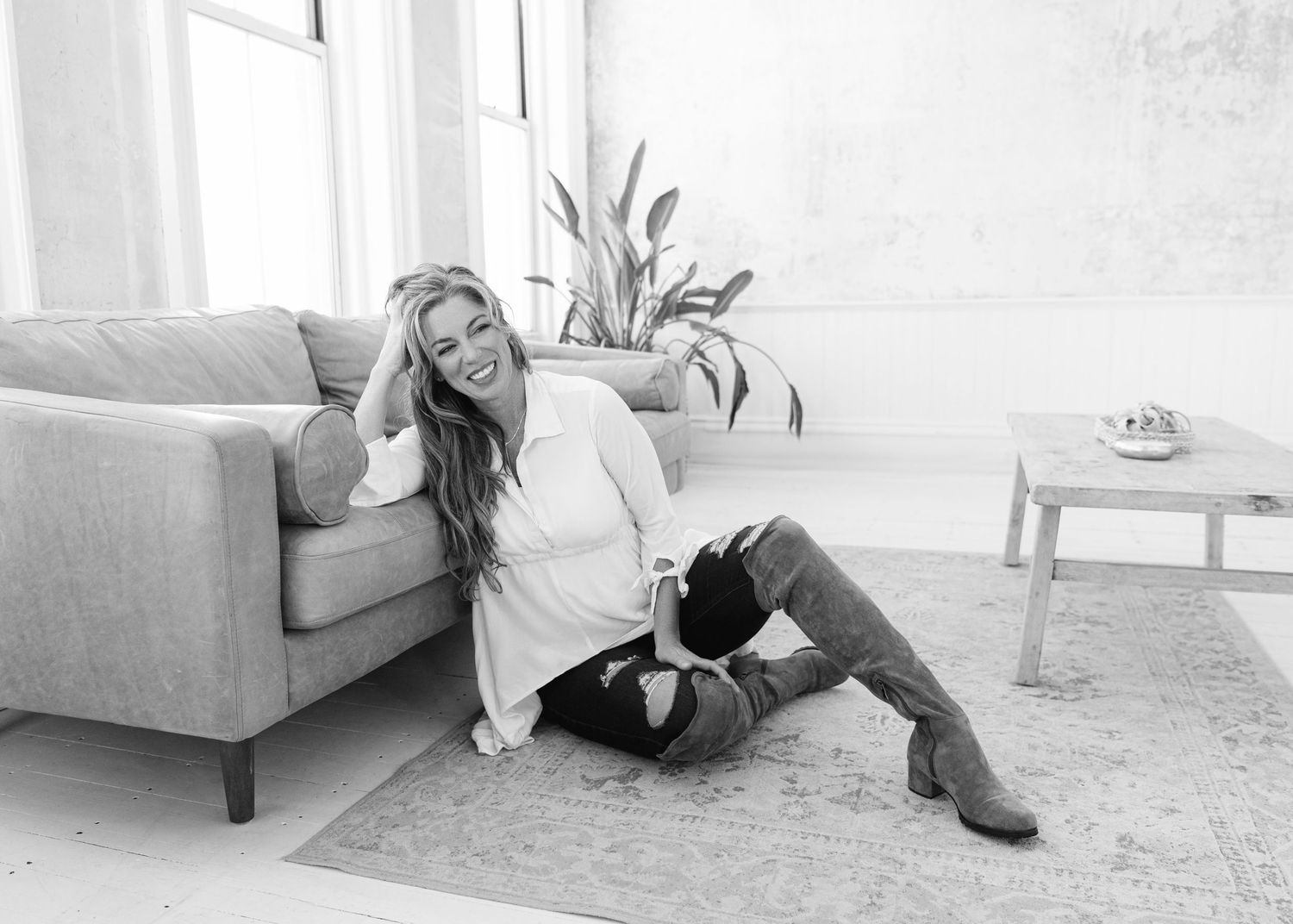 Artistic black and white lounging poses in minimalist interior setting.